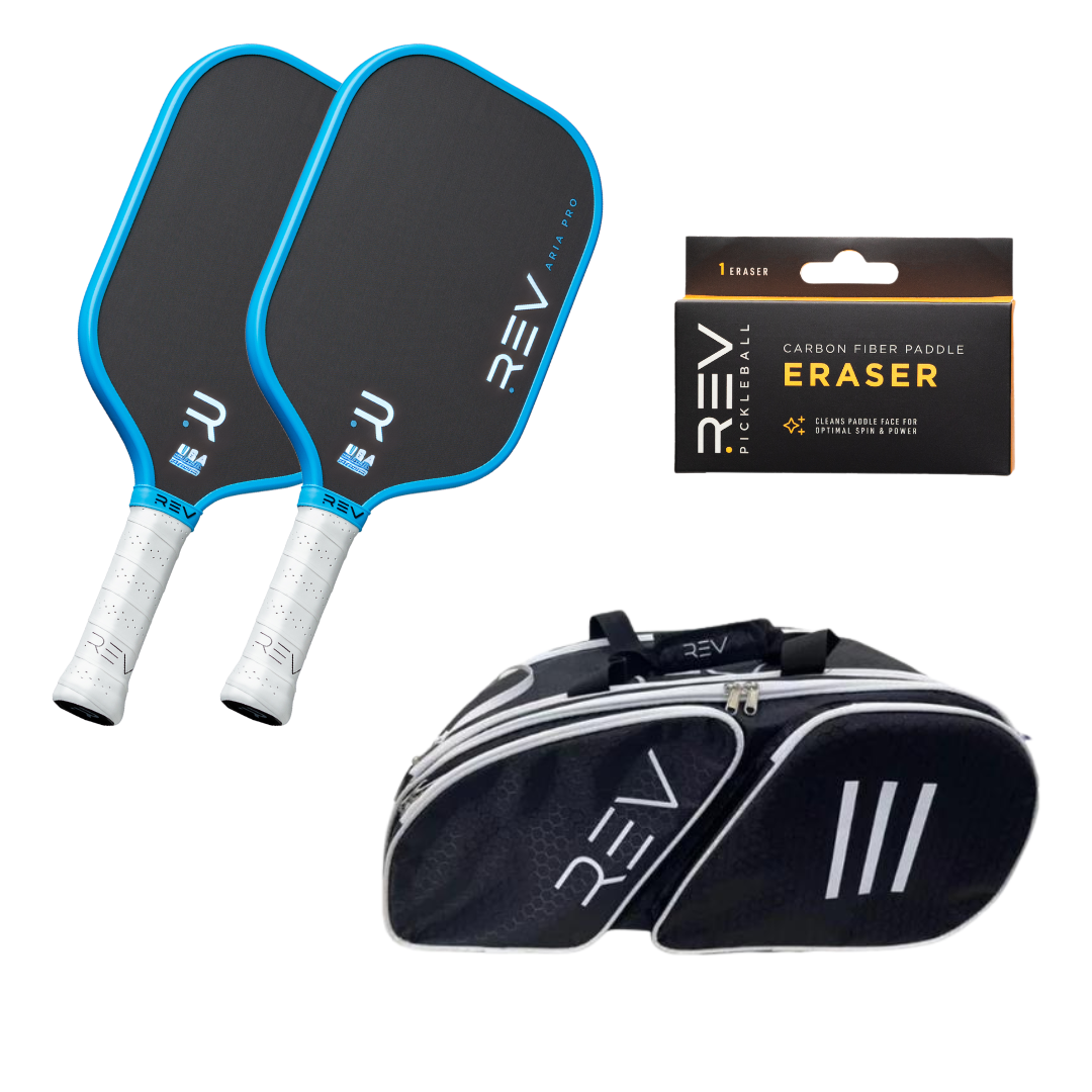 The REV Pickleball Professional - Mix & Match - Bundle for 2 includes two black and blue paddles with white grips, a black eraser box, and a black sports bag—all featuring the REV logo—displayed on a white background.