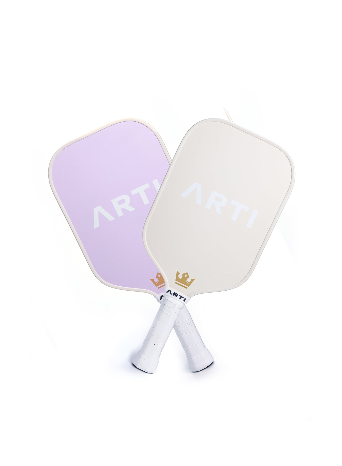 Two ARTI "Dogs & Giraffes" Fiberglass Pickleball paddles cross at the handles on a white background. This USAPA approved set includes a light purple and an off-white paddle, each with "ARTI" and a gold crown above white grip tape handles.