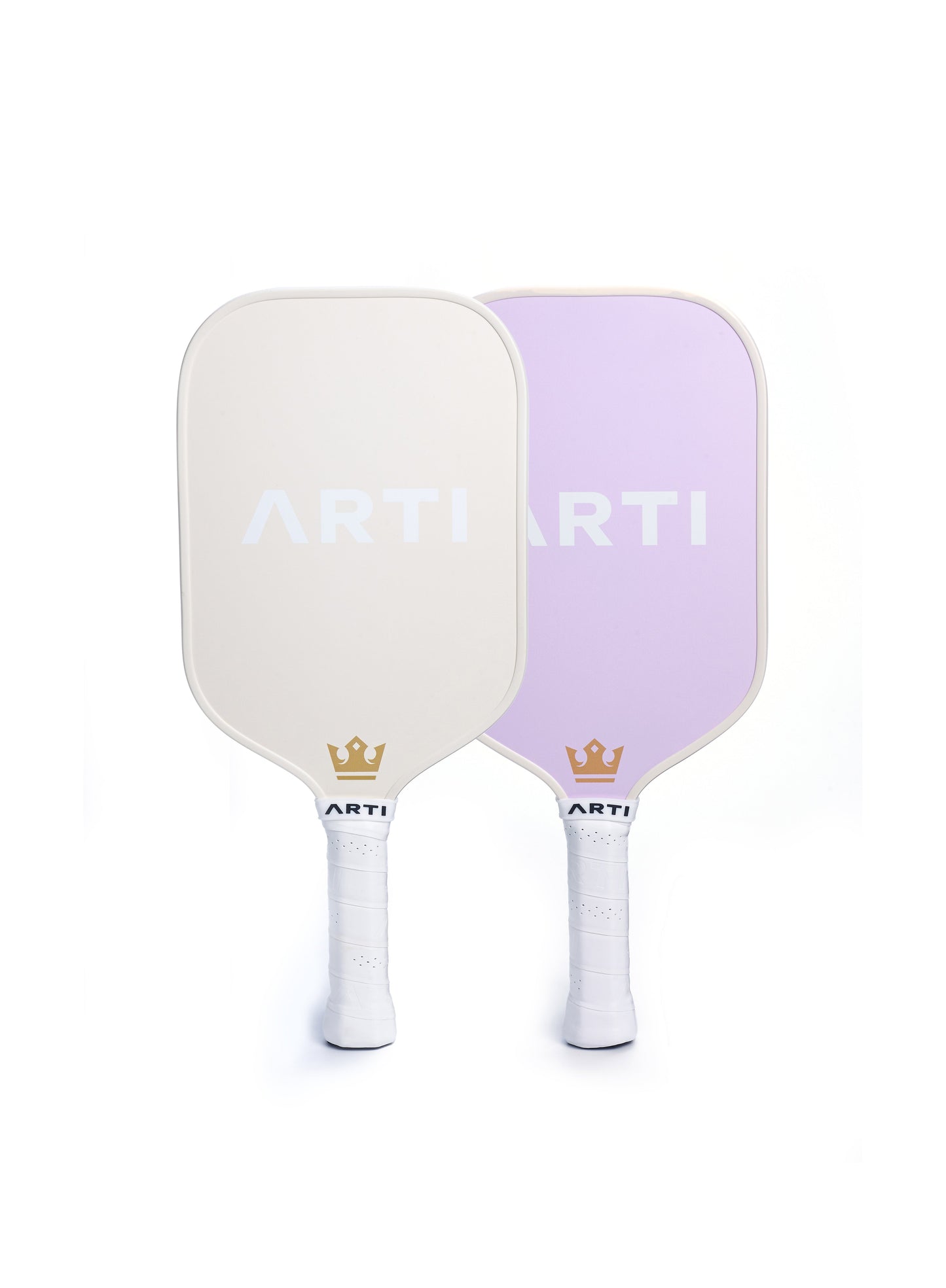 Two ARTI Fiberglass "Dogs & Giraffes" pickleball paddles, USAPA approved, stand upright and overlap slightly—one off-white, one lavender. Both display the ARTI logo and a gold crown above their white grip tape handles for a stylish set.