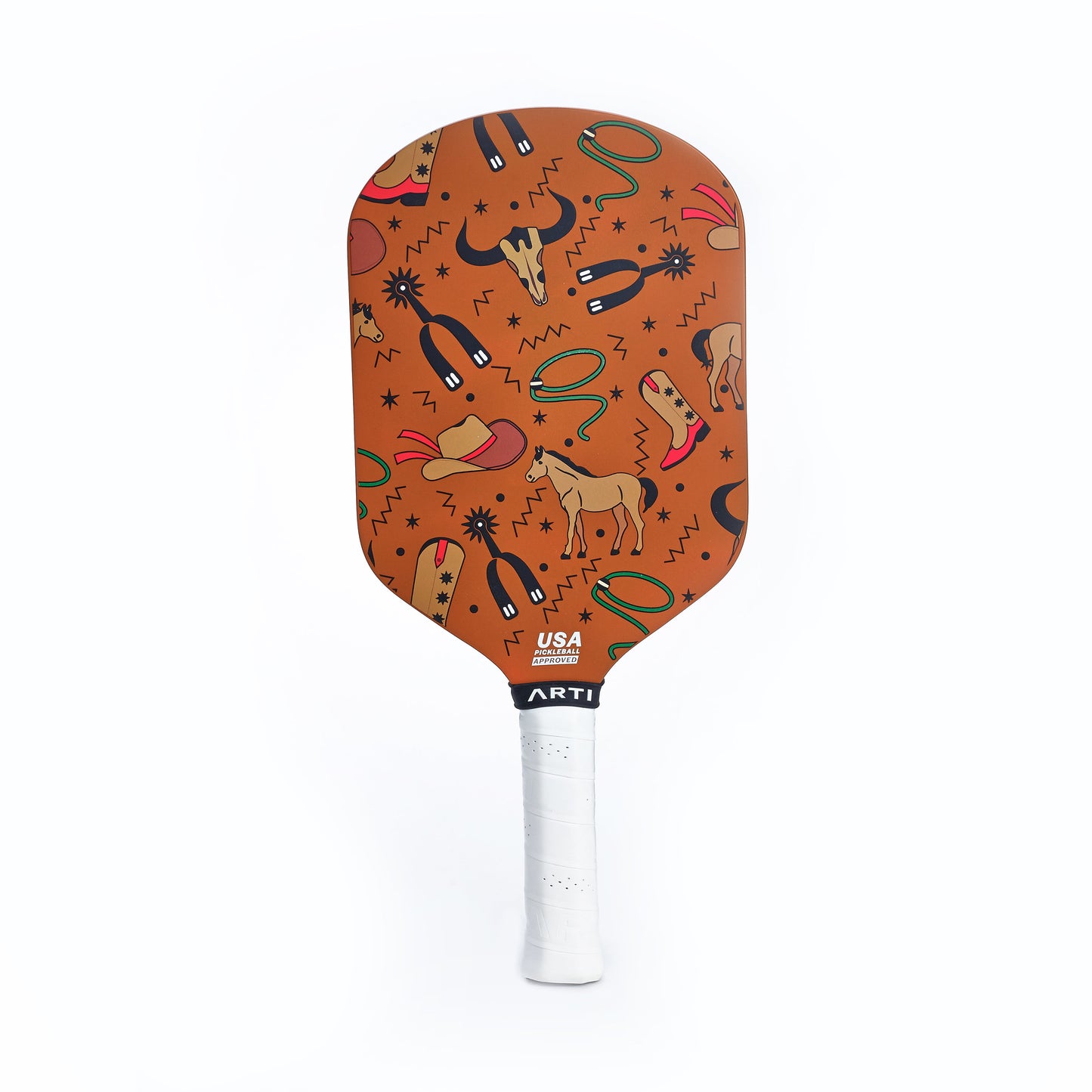 The ARTI Carbon Fiber "TEXAS" Paddle by ARTI features a white grip and an orange face adorned with playful black, brown, green, and yellow illustrations of horses, cowboy hats, cacti, lassos, boots, and zigzags on a white background.