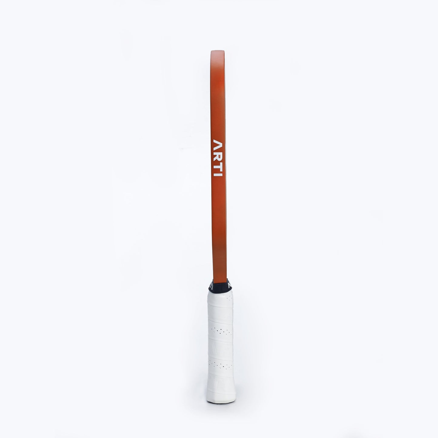 An ARTI Carbon Fiber "TEXAS" Paddle stands vertically against a plain white background. The white-taped grip and orange frame have "ARTI" in bold white letters along the side. The image is minimalistic and centered.