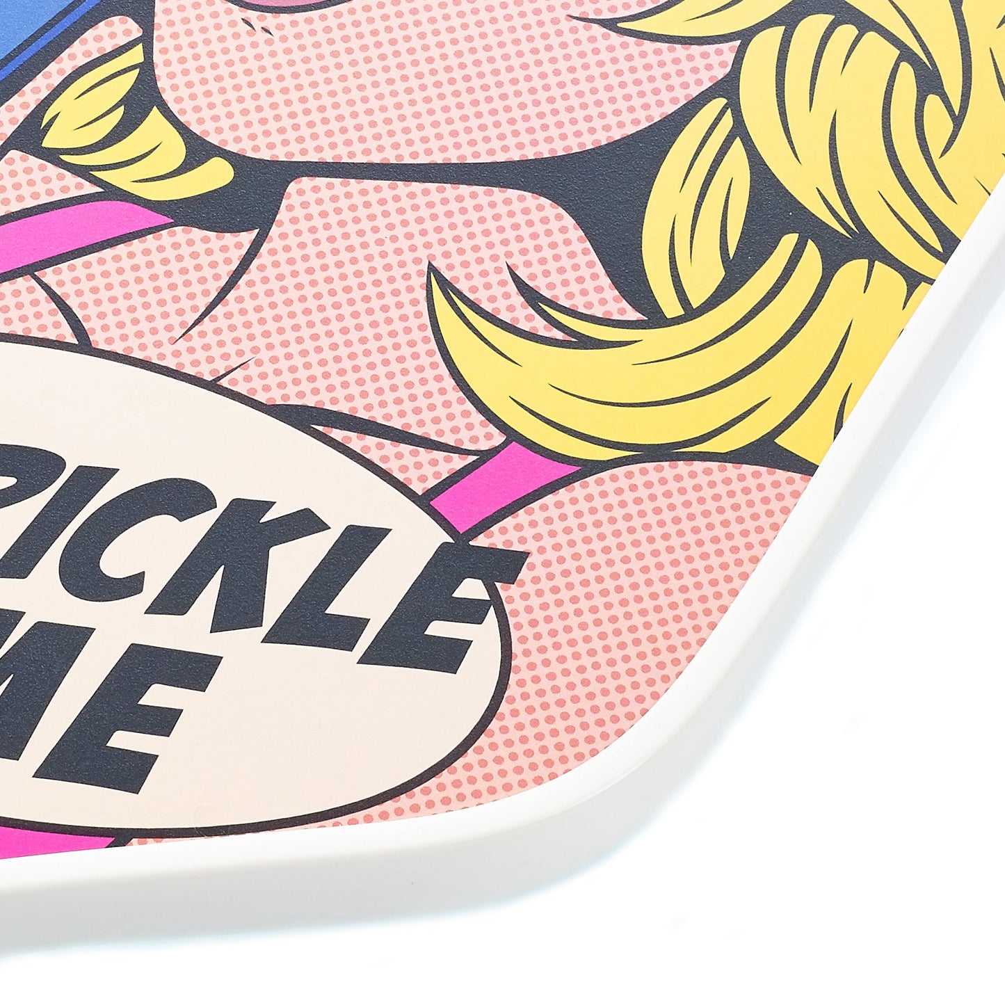 A pop art-style design on the ARTI Carbon Fiber Kristen & Kristy "IT'S PICKLE TIME" Paddle features a pink face, yellow hair, bold outlines, and a dotted halftone background with a bubble reading CKLE ME—a playful tribute to pickleball fun.