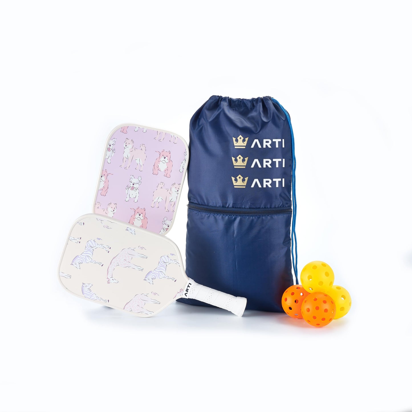 The ARTI Fiberglass "Dogs & Giraffes" Pickleball Paddle Set includes two paddles with animal designs, a navy ARTi drawstring bag, and four orange balls—USAPA approved and great for all skill levels.