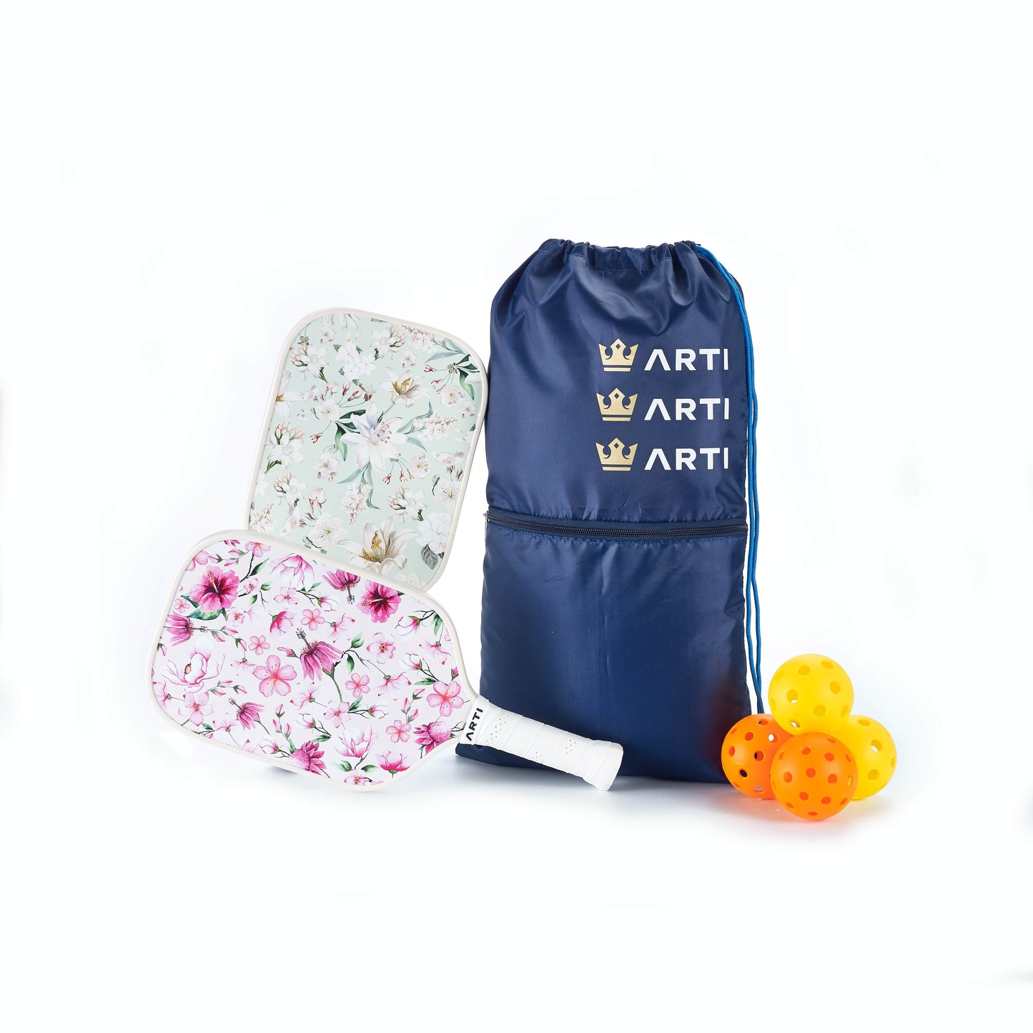 The ARTI Fiberglass "Flowers" Pickleball Paddle Set features two USAPA-approved paddles—one with pink flowers, one with green leaves—a navy blue ARTI drawstring bag, and four yellow pickleballs arranged on a white background.