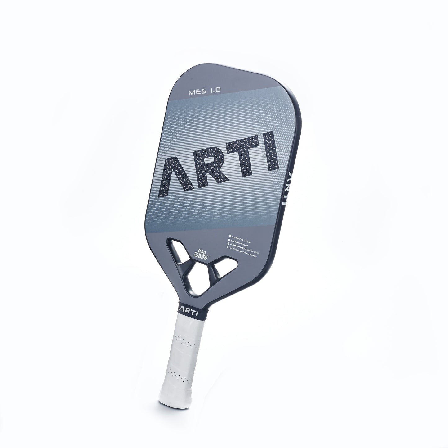 The ARTI Carbon Fiber "MASTERY ELITE 1.0" paddle features a USAPA-approved gray and black T700 carbon fiber face with bold “ARTI” lettering, a geometric throat design, and a white grip, shown angled on a minimal white background.