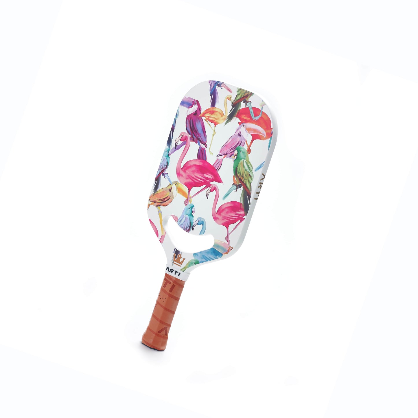 The ARTI Carbon Fiber EXOTIC TRIPIMAL "Flamingo" Paddle is a USAPA-approved paddle with a tan leather grip and white carbon fiber face, featuring vibrant pink, purple, green, and blue flamingos against a clean white background.