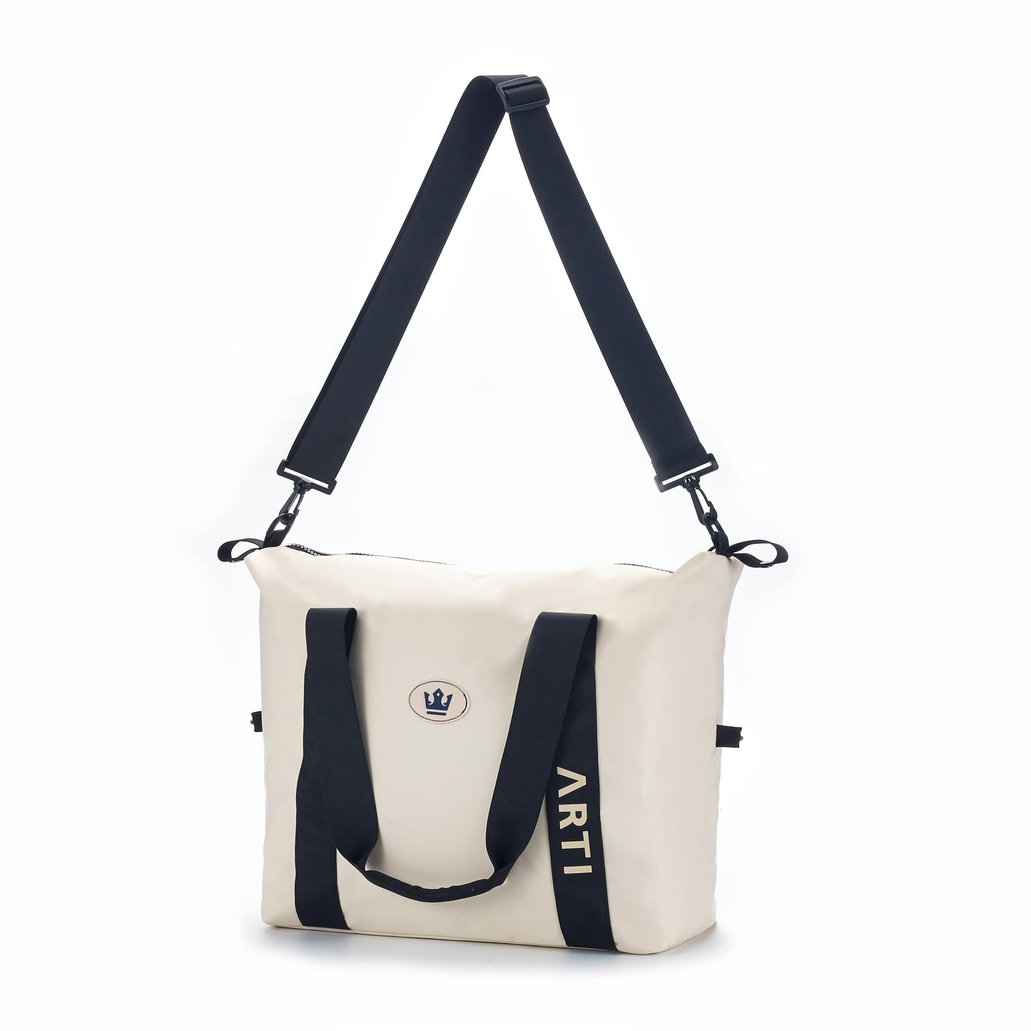 The ARTI Cream Duffle Bag features black handles, an adjustable shoulder strap, a crown emblem, and “ARTI” printed vertically in black on one side. Made of polyester by ARTI. Plain white background.