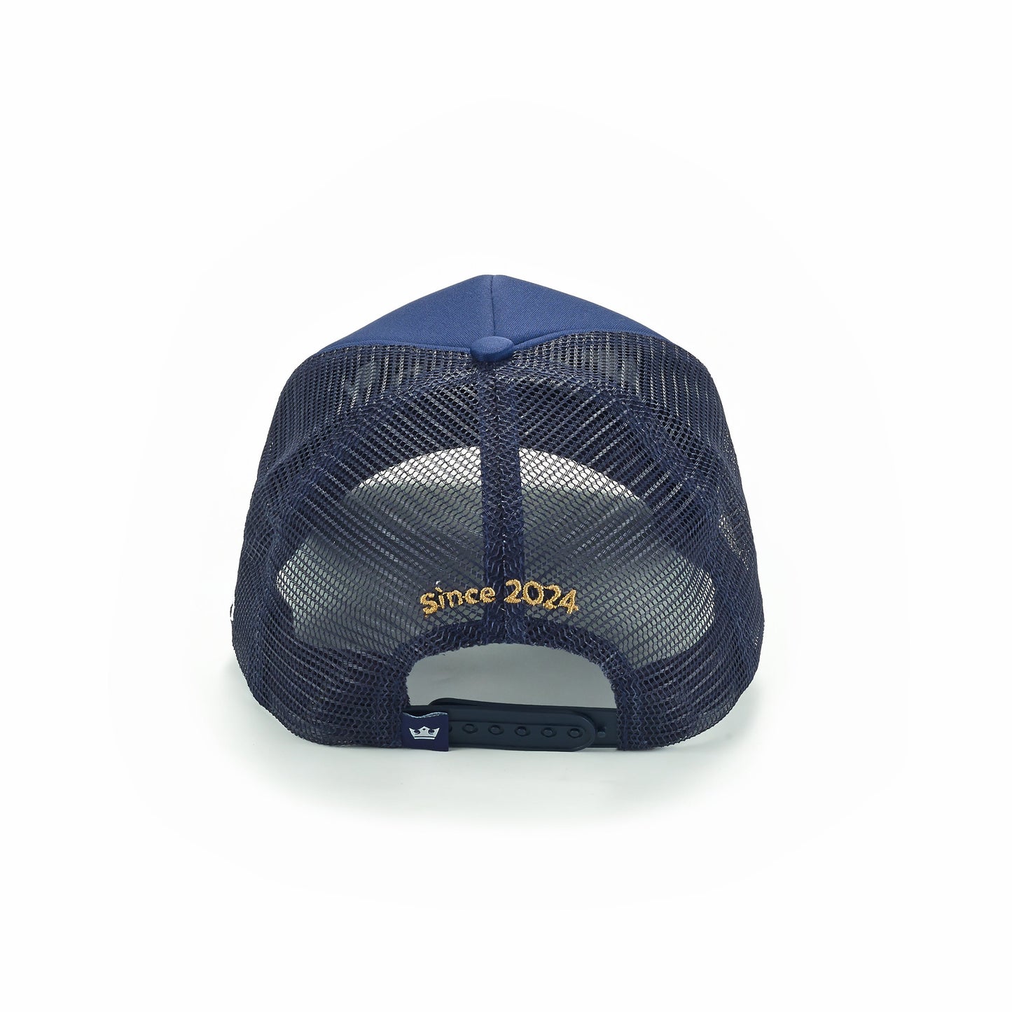 The ARTI Ain't No Party Like ARTI Trucker Hat is a navy mesh-back cap with yellow "Since 2024" embroidery above the adjustable snapback, a solid blue top button, and a small fabric tag by the closure.