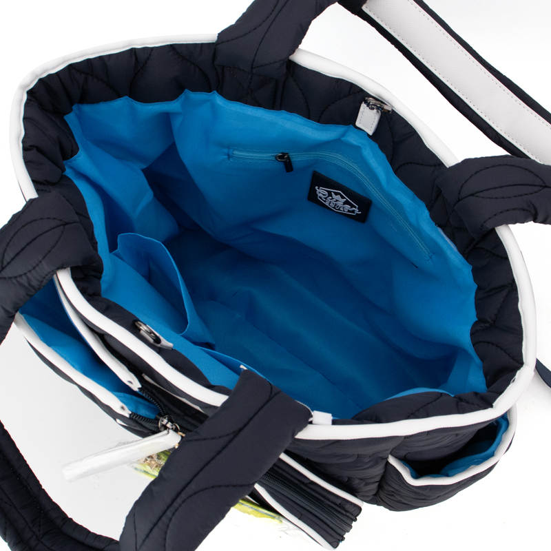 The Queen of the Court Park Ave Tennis Convertible Bag/Backpack for women features a navy exterior with white accents, sturdy padded handles, visible stitching, a bright blue interior, zippered pocket, and open compartments for organization.