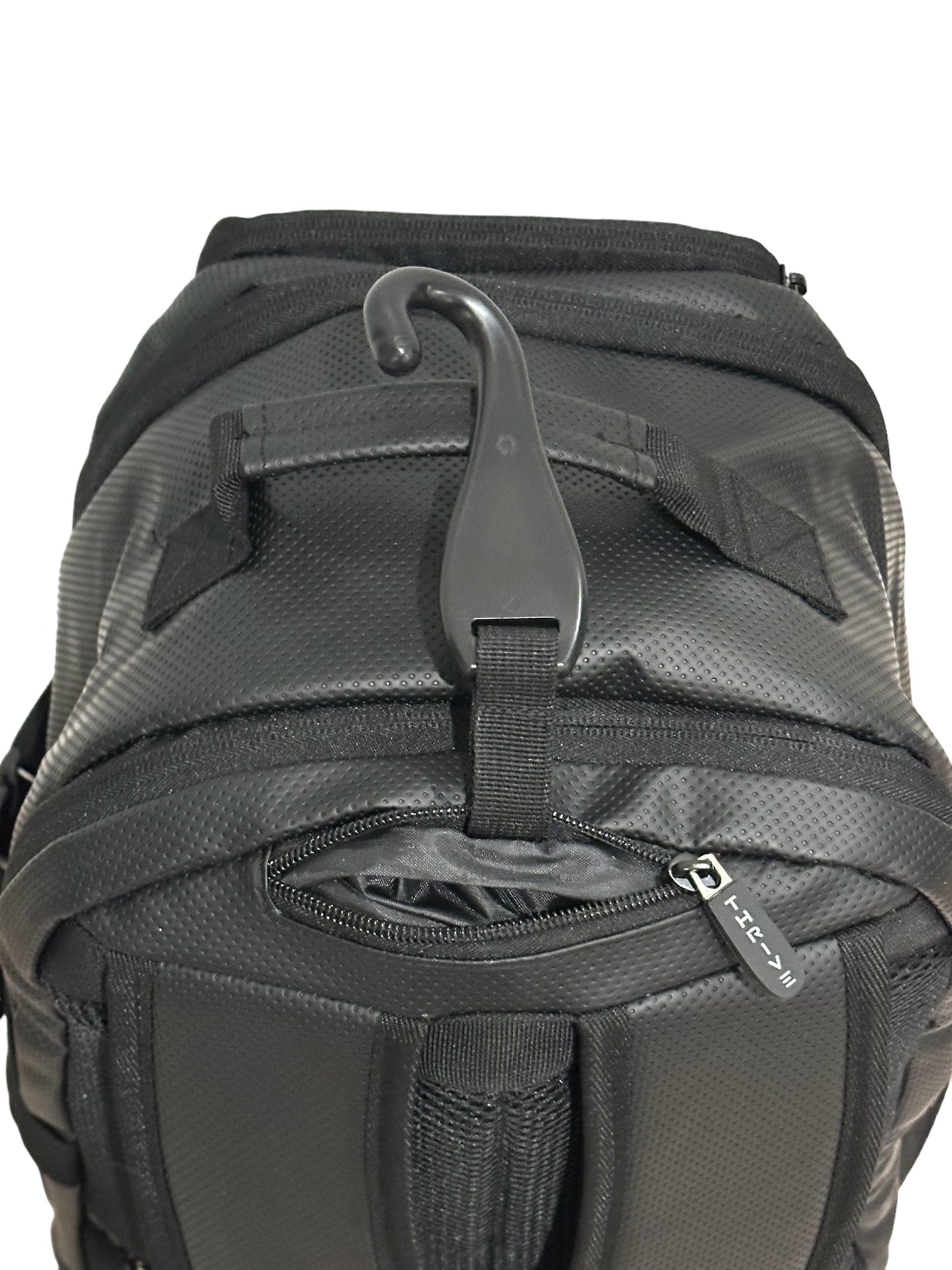 The Elite Backpack w/shoe bag by Thrive Pickleball is shown from the back in black vegan leather, featuring a textured material, a black plastic hook on a top loop, and a zipper with a HEX-labeled pull tab near the bottom.