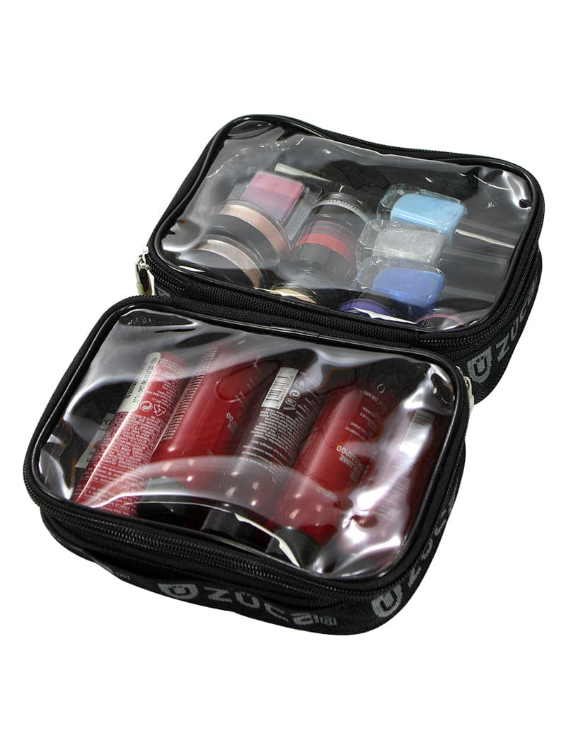 The ZUCA Mini Utility Pouch Duo features a black zippered design with clear vinyl compartments to organize red bottles, such as shampoo and conditioner, below and store small makeup containers, like compacts and colorful square cases, above.