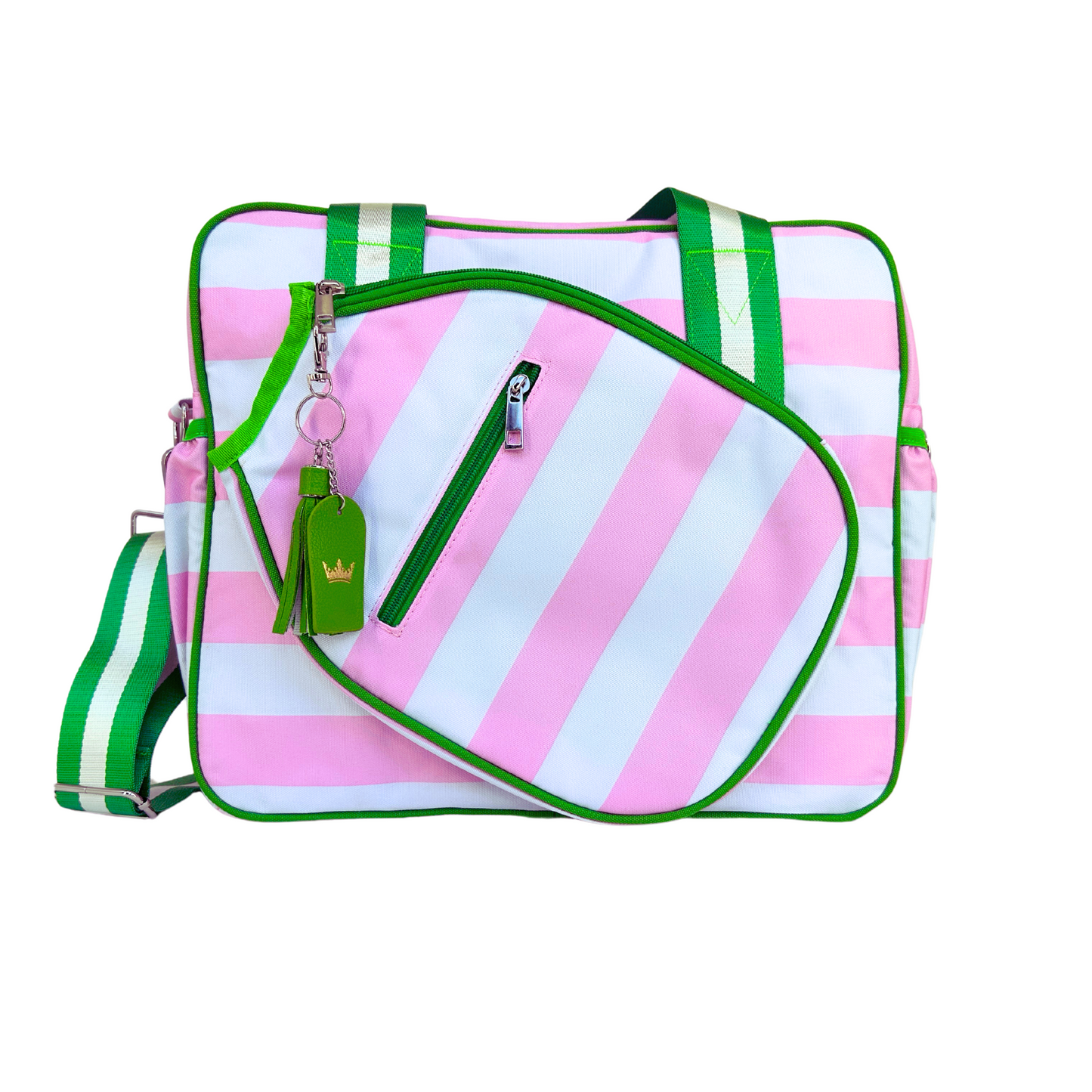 The Prepster Pickleball Bag by Queen of the Court is a rectangular tote with pink and white stripes, green trim, striped handles, an angled dual-zip front pocket, and a green tag keychain with a yellow crown. Shown on a white background.