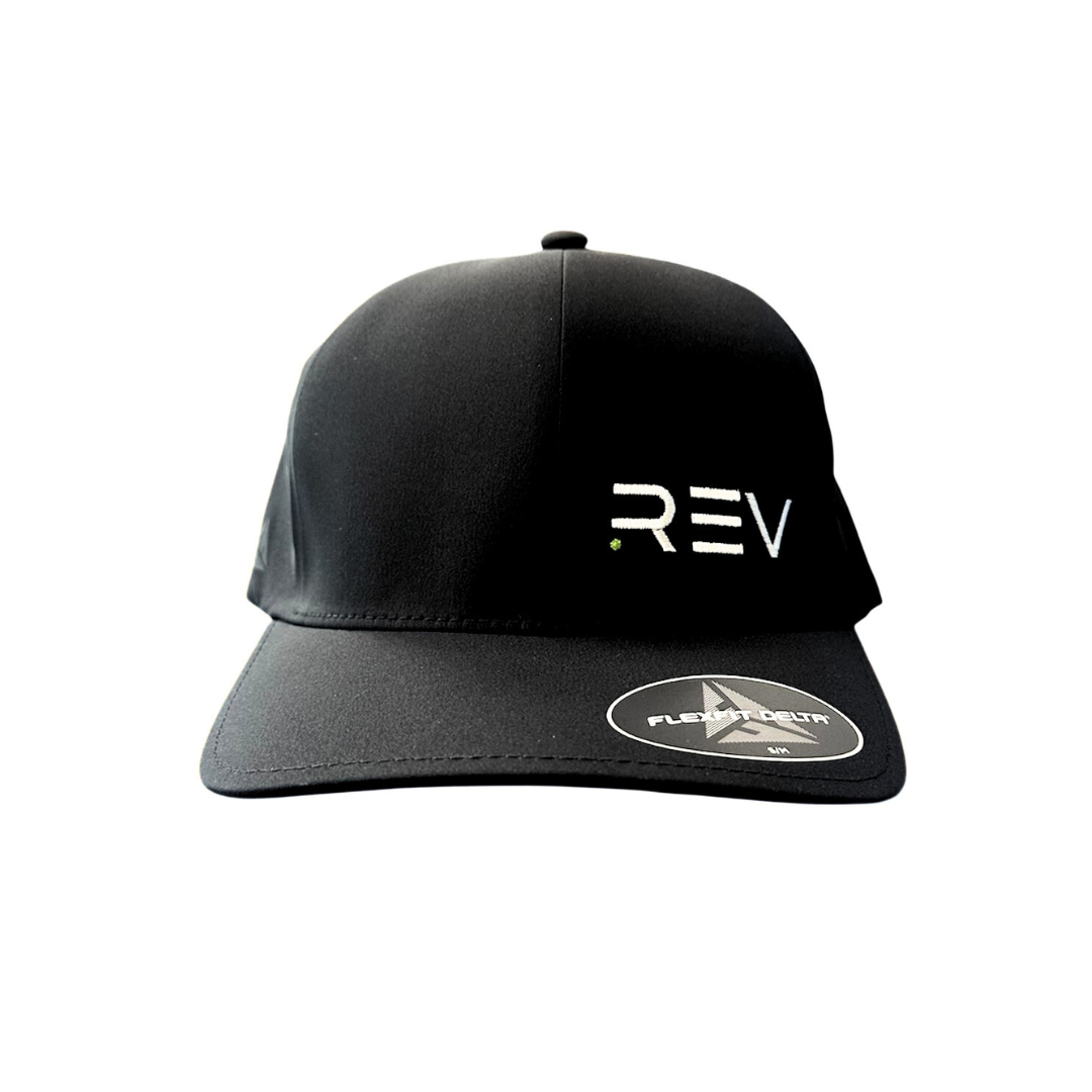 The Black Flexfit Hat by REV Pickleball features ".REV" embroidered in white with a green dot on the front panel and has a curved brim with a FLEXFIT DELTA sticker indicating the fit.