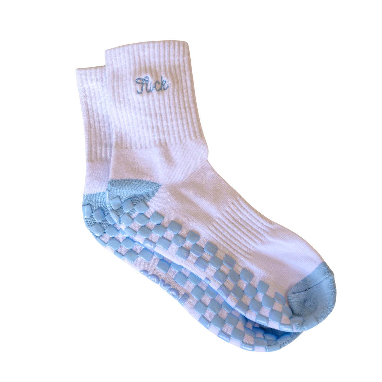 The Pardon My French Grip Sock by Revel is a white crew sock with light blue toes and heels, blue checkered non-slip grips, and “sick” embroidered in blue near the top. The background is plain white.