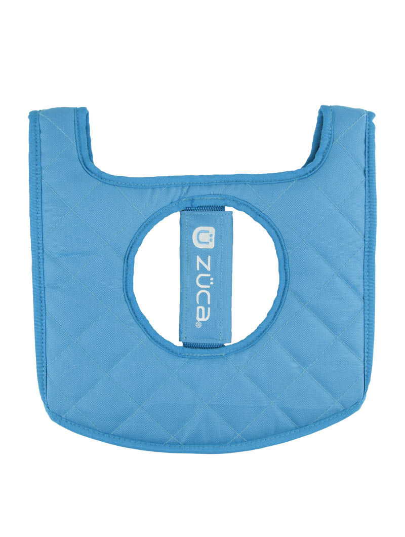 The ZUCA Reversible Seat Cushion features a quilted light blue, diamond-stitched design with rounded corners, a large circular center cutout, and a branded handle, offering both practical comfort and stylish appeal.