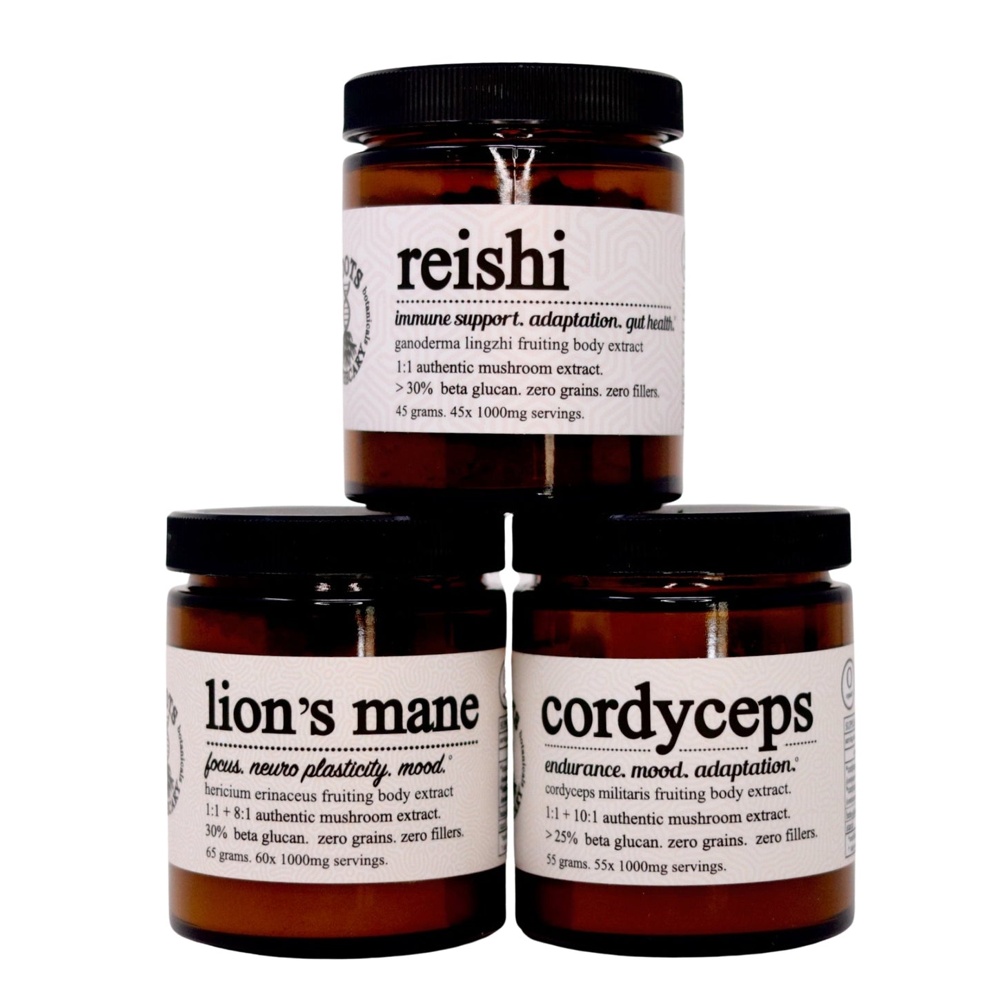 Three brown glass jars labeled reishi, lion’s mane, and cordyceps are stacked. Each Roots Apothecary “3 pack shroom stack” jar details 100% fruiting body mushroom extracts, beta-glucans content, benefits, ingredients, and serving size.