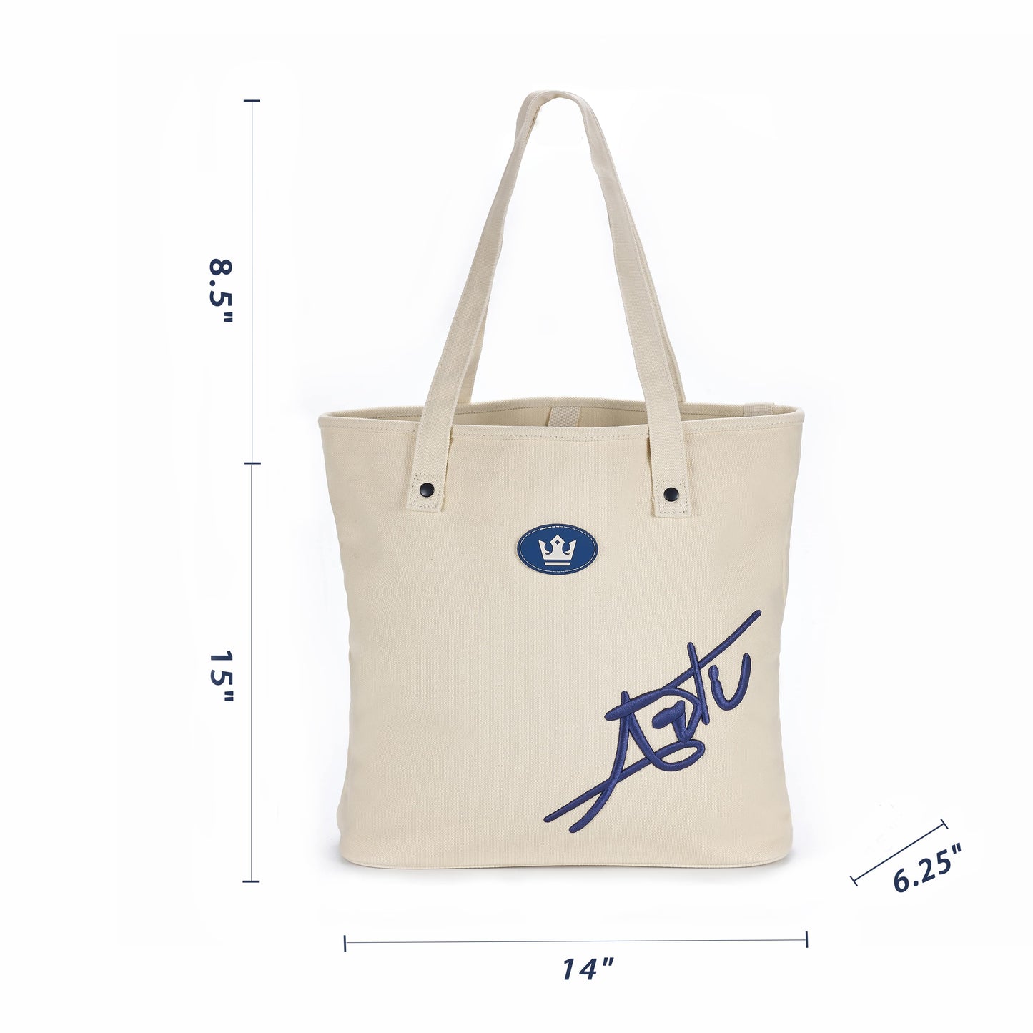The ARTI Cream Tote Bag by ARTI features a navy crown emblem and large signature on the front. Made from durable cotton, it measures 15"H x 14"W x 6.25"D with an 8.5" handle drop for comfortable, eco-friendly carrying.