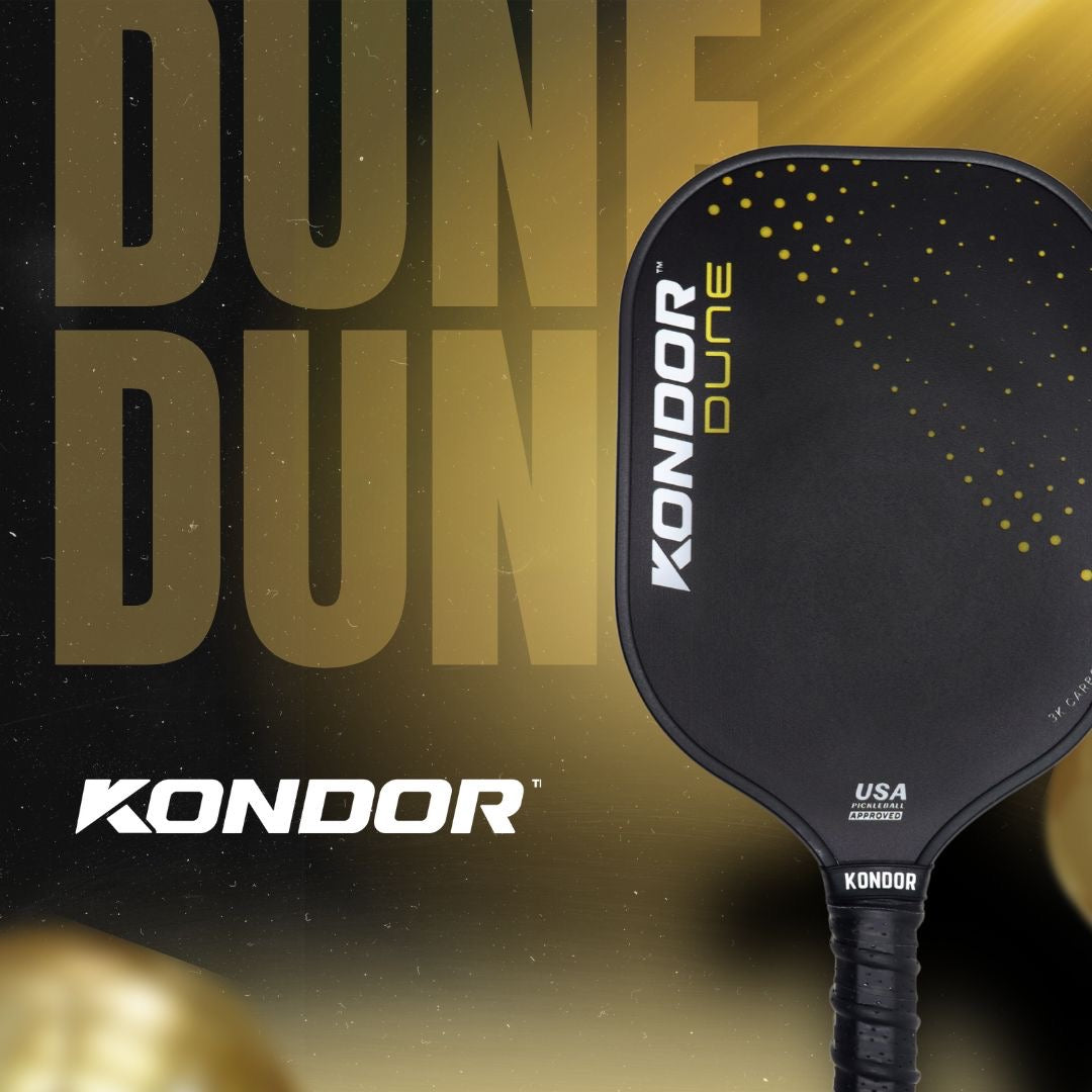 A close-up shows the black DUNE 3K Carbon Pickleball Paddle by KONDOR PICKLEBALL with a 3K carbon face, yellow dots, and "KONDOR DUNE" text. In the blurred background, large gold "DUNE" lettering glows with gold lighting.