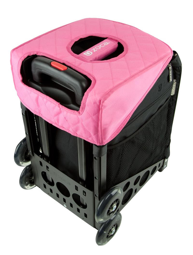 A black ZUCA rolling bag with four wheels and a pink quilted cover featuring a handle cutout, ZUCA logo, mesh pockets, sturdy base, and space for a ZUCA Reversible Seat Cushion or other accessory.