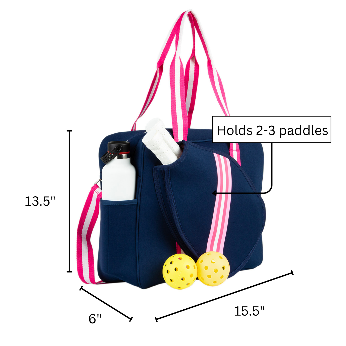 The Queen of the Court Brooklyn Pickleball Bag in navy blue with pink and white striped straps holds a water bottle, white towel, and fits 2-3 paddles. Two yellow pickleballs are in front. Size: 13.5"H x 6"W x 15.5"L; neoprene material.