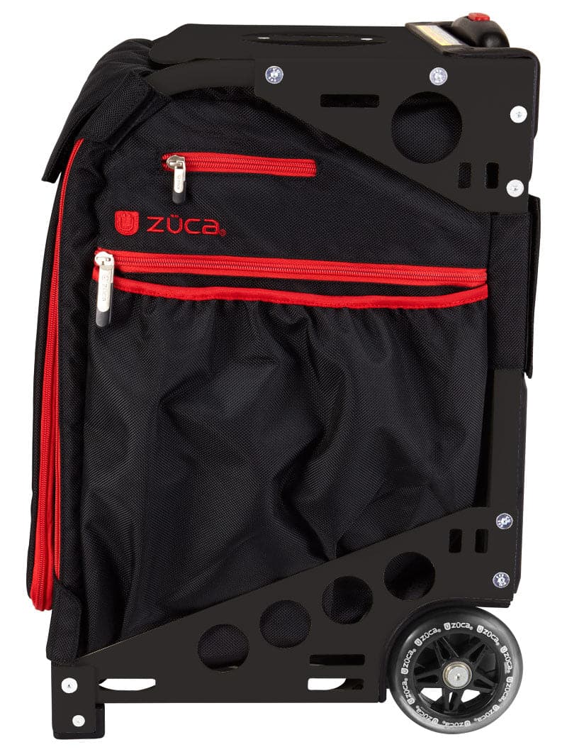 The ZUCA Pickleball Pro Black/Red rolling bag has a sturdy metal frame with circular cutouts, two large wheels, a fabric compartment with red zippers, a side mesh pocket, and the logo above the front zipper.