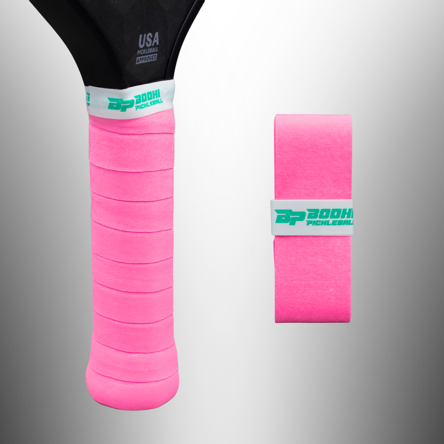On the left is a pickleball paddle handle wrapped in bright pink DRYtack™ Premium Pickleball Overgrips by Bodhi Performance. On the right, a roll of the same overgrip with a white and green Bodhi Performance band is shown against a gray background.