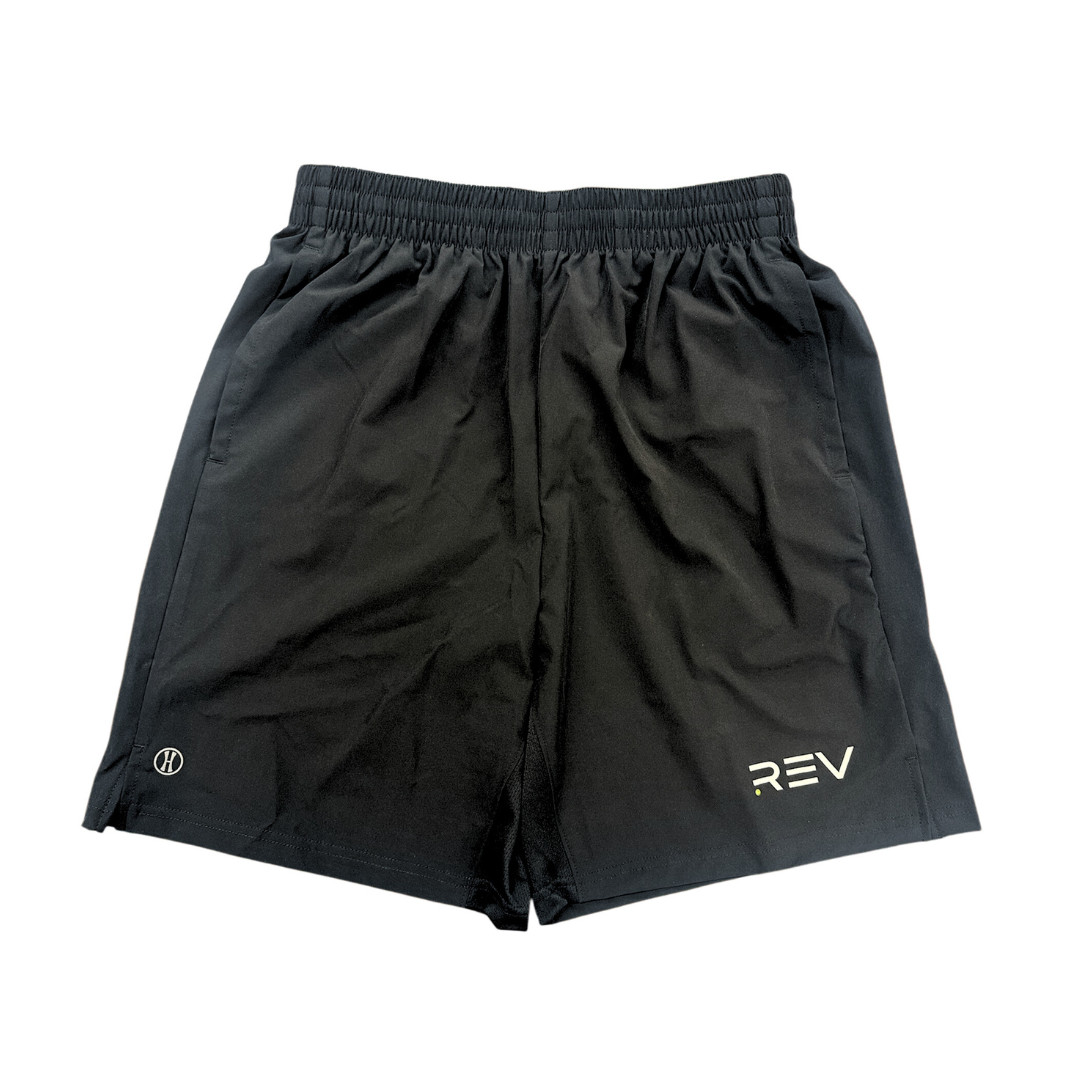 The REV Pickleball Black Activeware Shorts feature an elastic waistband, lightweight moisture-wicking fabric, a small white logo on the left leg, and a circular logo near the right hem for comfort in any activity.