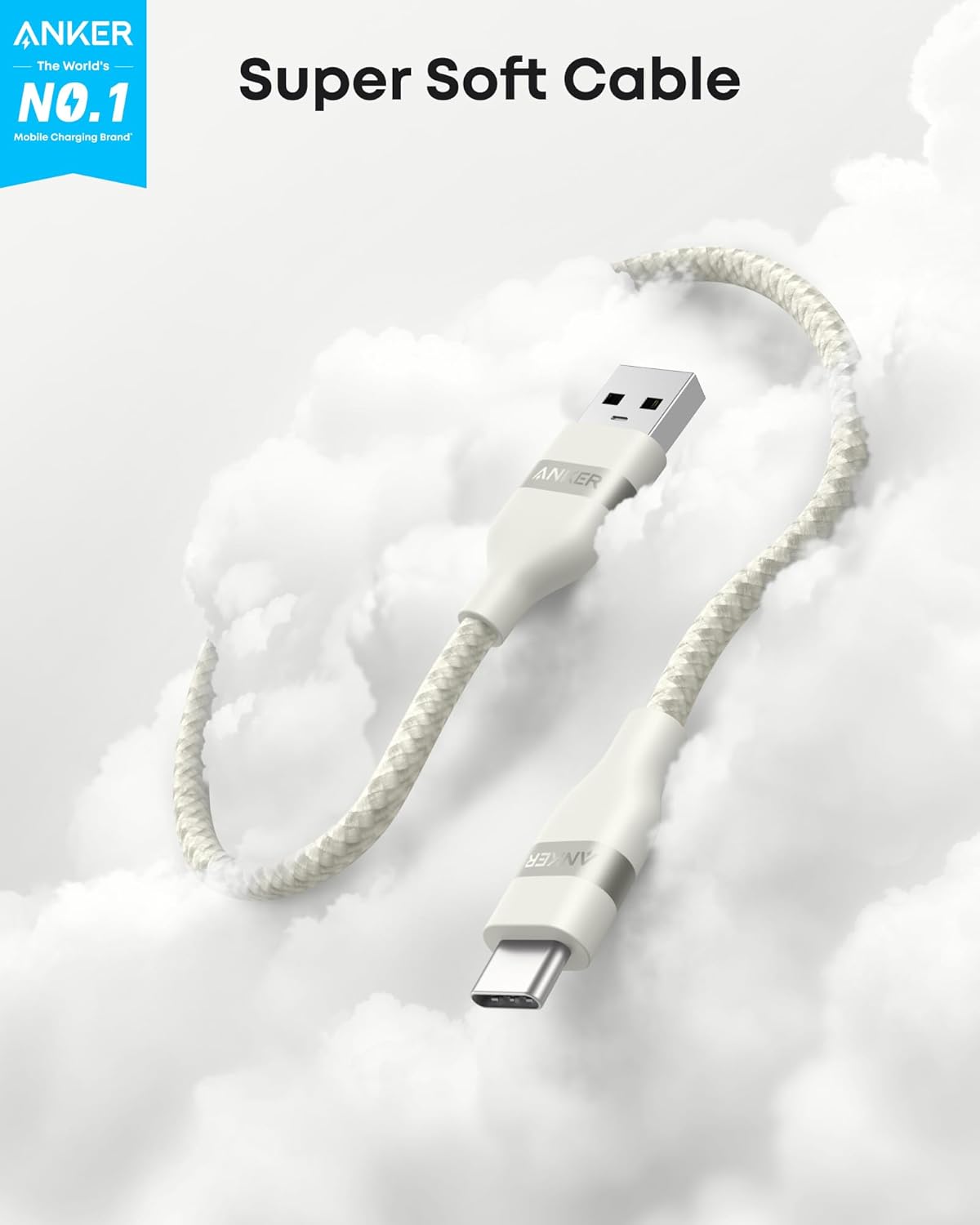 A white Anker USB-A to USB-C Cable (3 ft/6 ft, Upcycled-Braided) floats above clouds with the text “Super Soft Cable.” A blue label reads, “ANKER The World’s NO.1 Mobile Charging Brand.” The upcycled-braided design resists tangles.