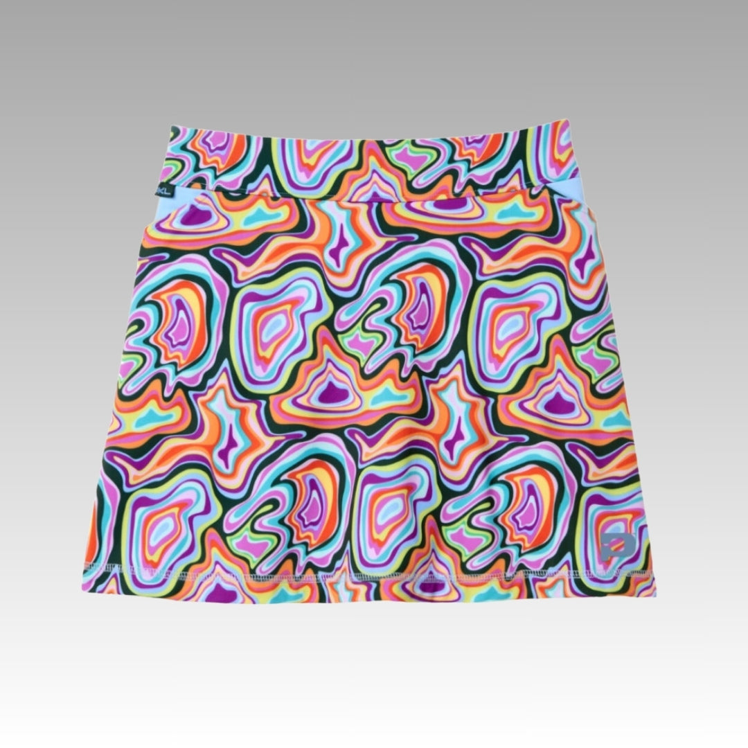 The Sammy Skort 2.0 by Playly Store features a bold, abstract swirl pattern in purple, orange, green, red, and blue on white. Made from CoolFlow moisture-wicking fabric and shown on a gradient gray-to-white background.