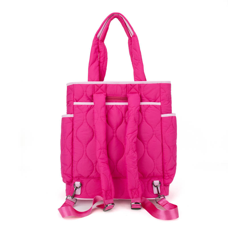 The Queen of the Court Fifth Ave Pickleball Convertible Tote Bag/Backpack features bright pink quilted design, two side pockets, adjustable straps, top handles, zippered main compartment, and stylish silver hardware accents.
