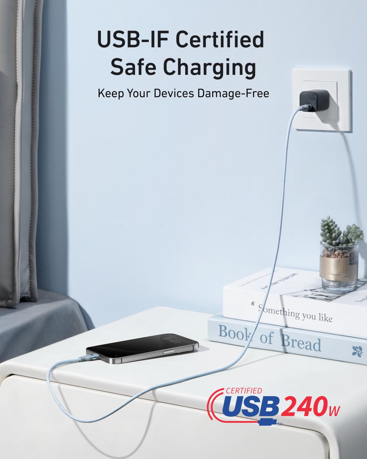 Anker’s USB-C to USB-C Cable (3 ft/6 ft, 240W, Upcycled-Braided) powers a phone on the bedside table. USB-IF Certified Safe Charging keeps devices damage-free. Book, lamp, and Certified USB 240W logo appear in the scene.