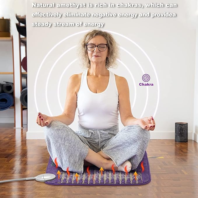 A middle-aged woman with glasses and curly hair meditates cross-legged on the iReliev Amethyst Far Infrared Heating Pad, which features orange energy lines. Text explains how amethyst enhances relaxation and pain relief by supporting energy flow.
