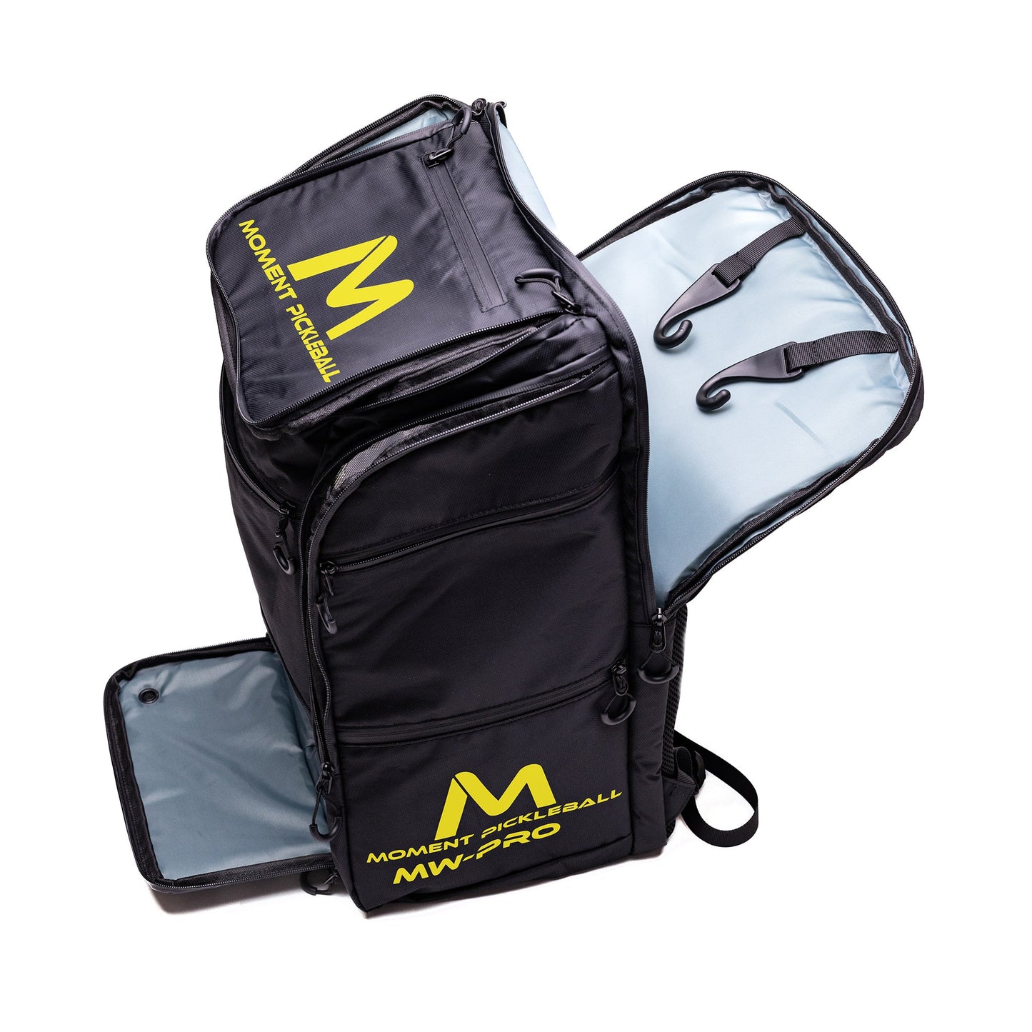 The Moment Pickleball MW-PRO Bag / Travel Bag Black/Yellow is shown open, displaying its light blue-grey interior, bold yellow branding, and multiple zippered pockets for organized pickleball equipment storage.