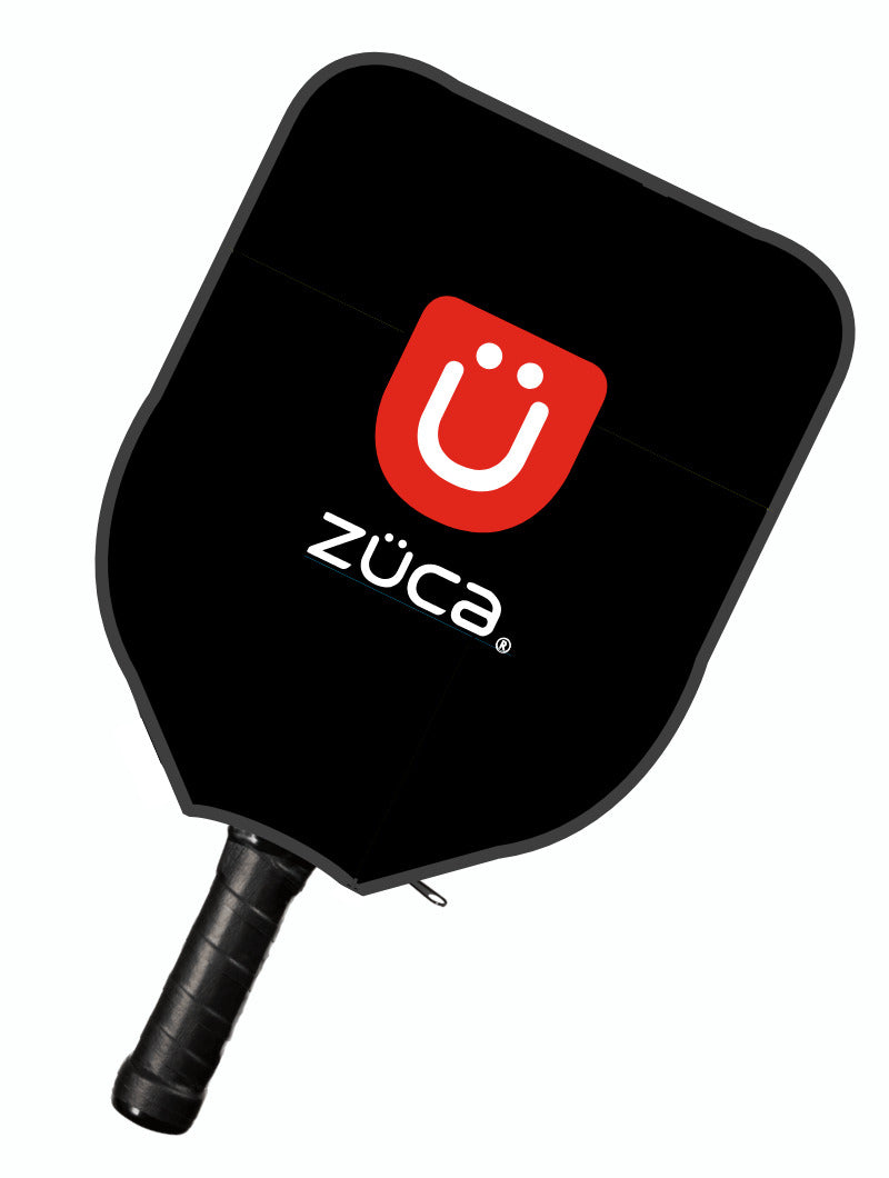 The ZUCA Pickleball Sport Black/Black paddle features a black design with a black grip, red square with a white smiley face and “ZÜCA” below it, plus dark gray edges—perfect to pair with your favorite pickleball bag.