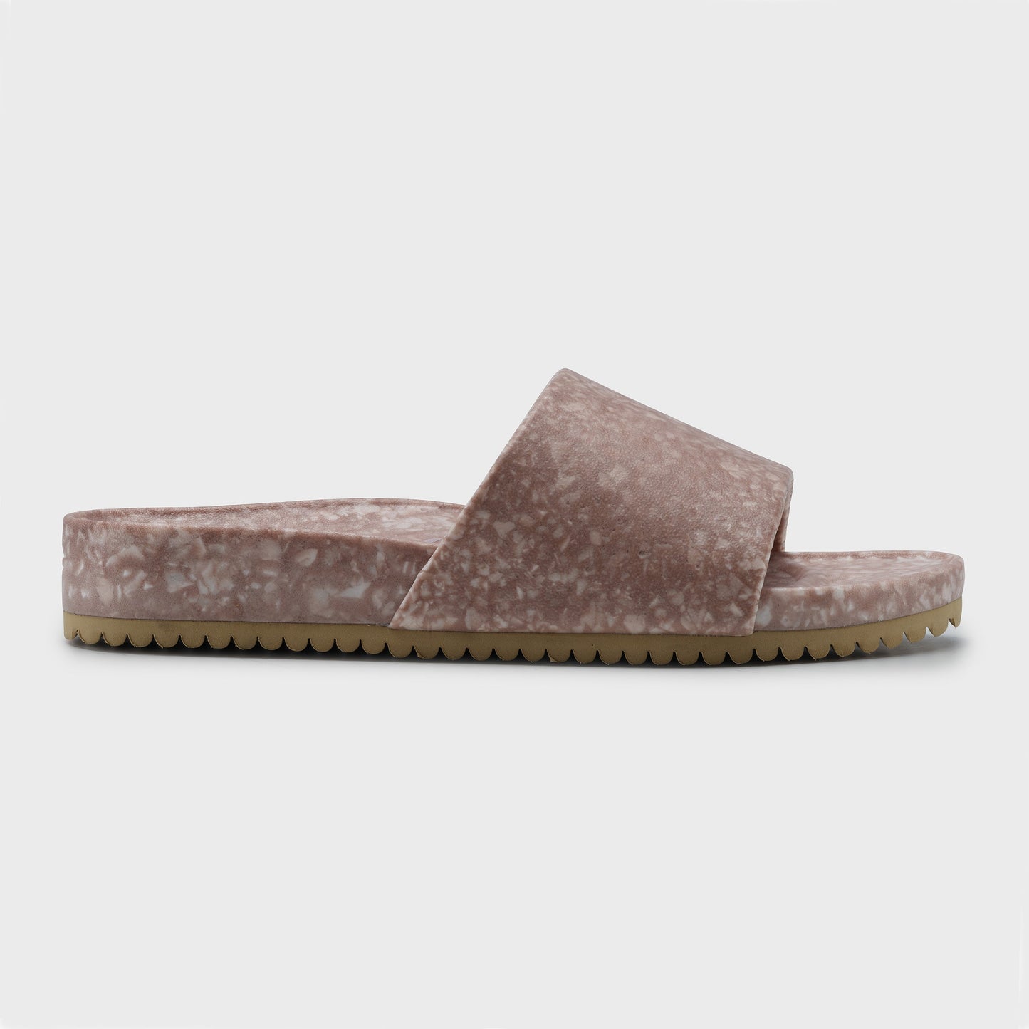 The Blumaka Fleks® East Beach Slide is a mauve-pink slide sandal with a plush upper, wide strap, marbled footbed for alignment support, and beige sole with toothed grip. Shown in left profile against a plain white background.