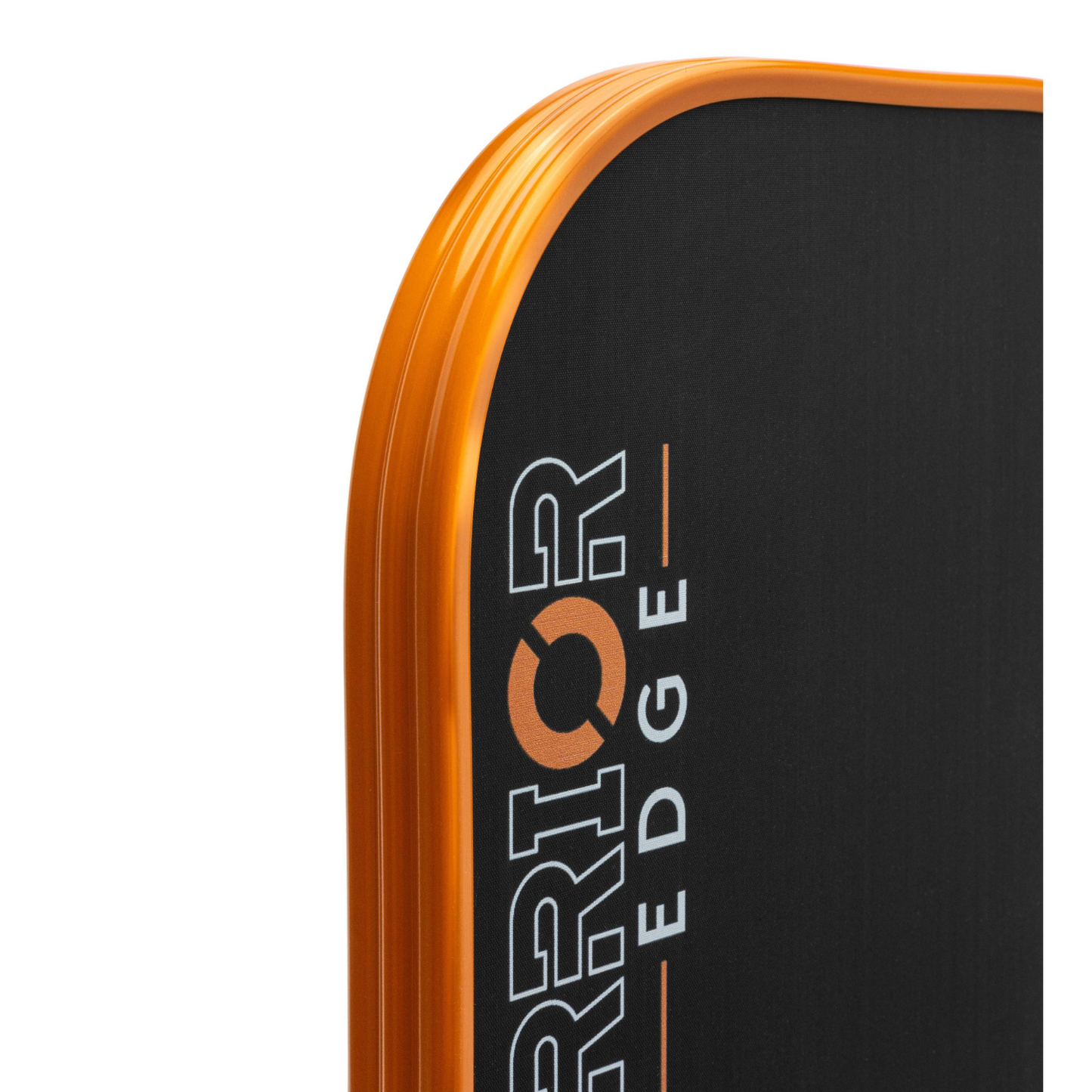 Close-up of the rounded edge of a rectangular black Diadem Sports Warrior Edge pickleball paddle with an orange border, featuring partial white text and a glimpse of the USAPA approved marking.