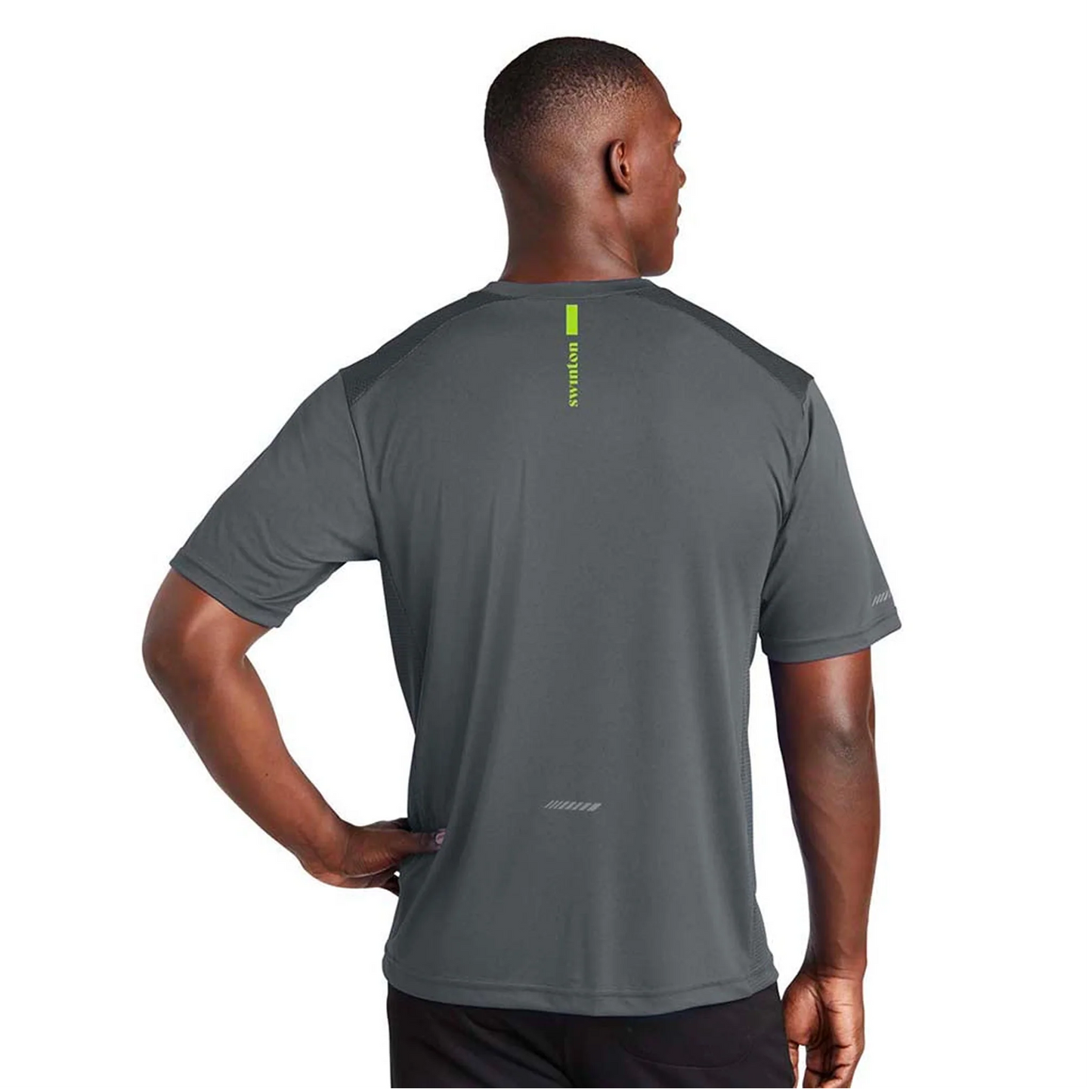 A man stands facing away, wearing the Swinton Pickleball Men's Kitchen's Closed Performance Shirt in gray with neon green text and accents. This moisture-wicking, short-sleeve pickleball top is shown against a plain white background, one hand on his hip.