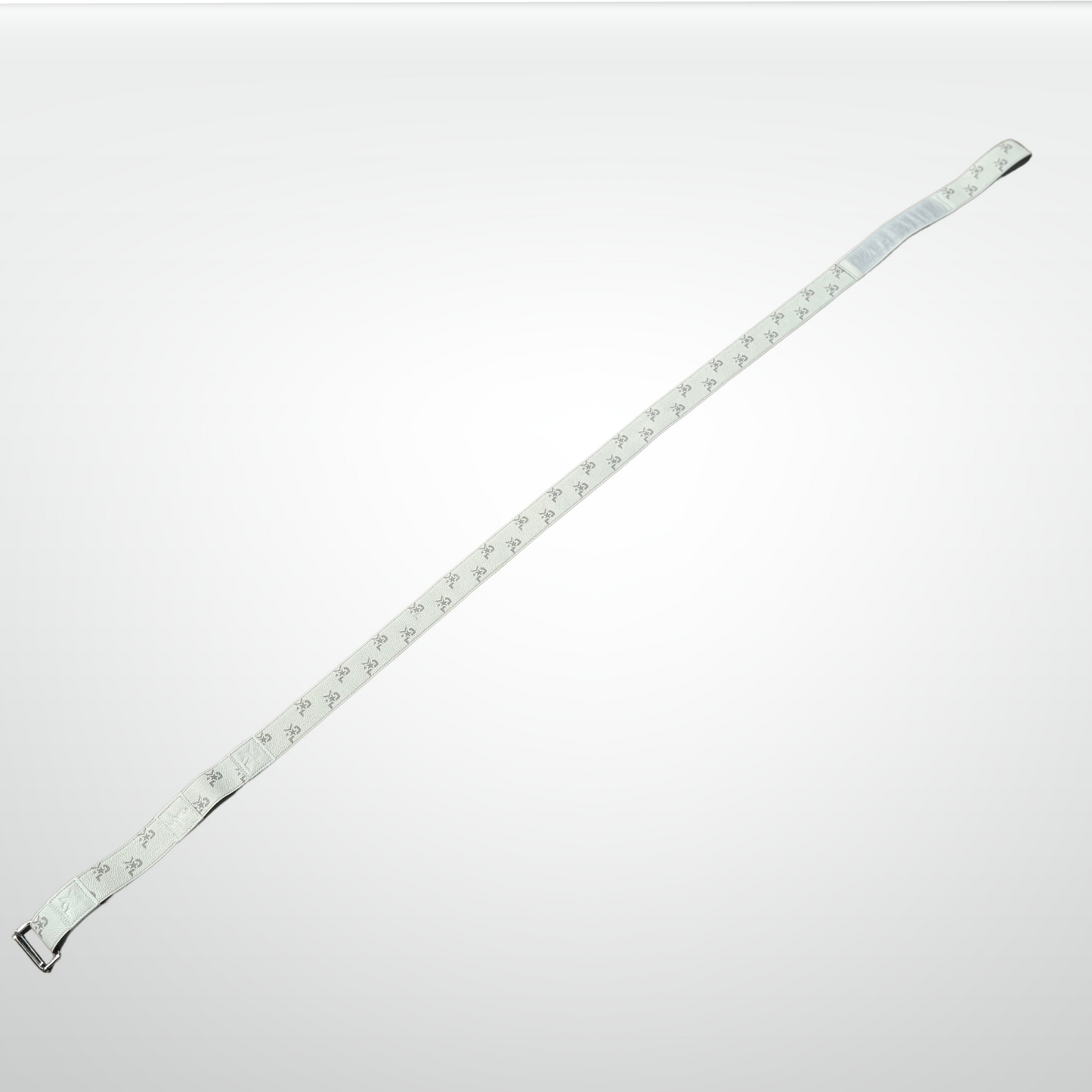 The iReliev I AM Leather Monogram Yoga Strap, featuring a metal buckle and a repeating dark monogram pattern, is laid diagonally on a light gray background—an accessory for those who demand best-in-class style.