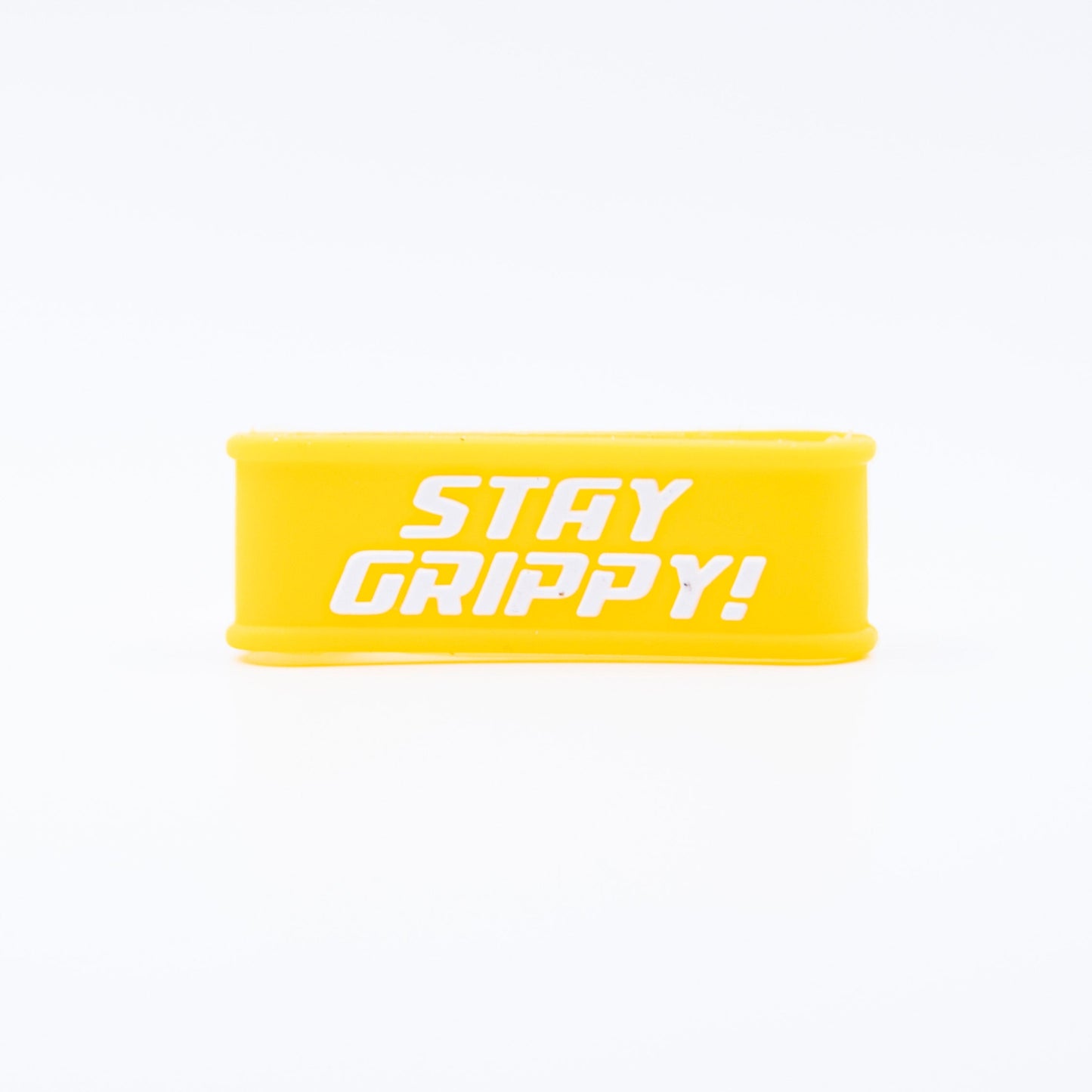 The Bodhi Performance Paddle Bands are bright yellow silicone grip bands for pickleball paddles, featuring bold white “STAY GRIPPY!” text. Displayed upright on a plain white background to showcase the design.