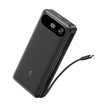 The Anker Power Bank (20K, 87W, Built-In USB-C Cable) is a sleek black 20000mAh device with a digital display showing 100, fast charging, two top USB ports, and an integrated right-side cable. The Anker logo is on the lower left.