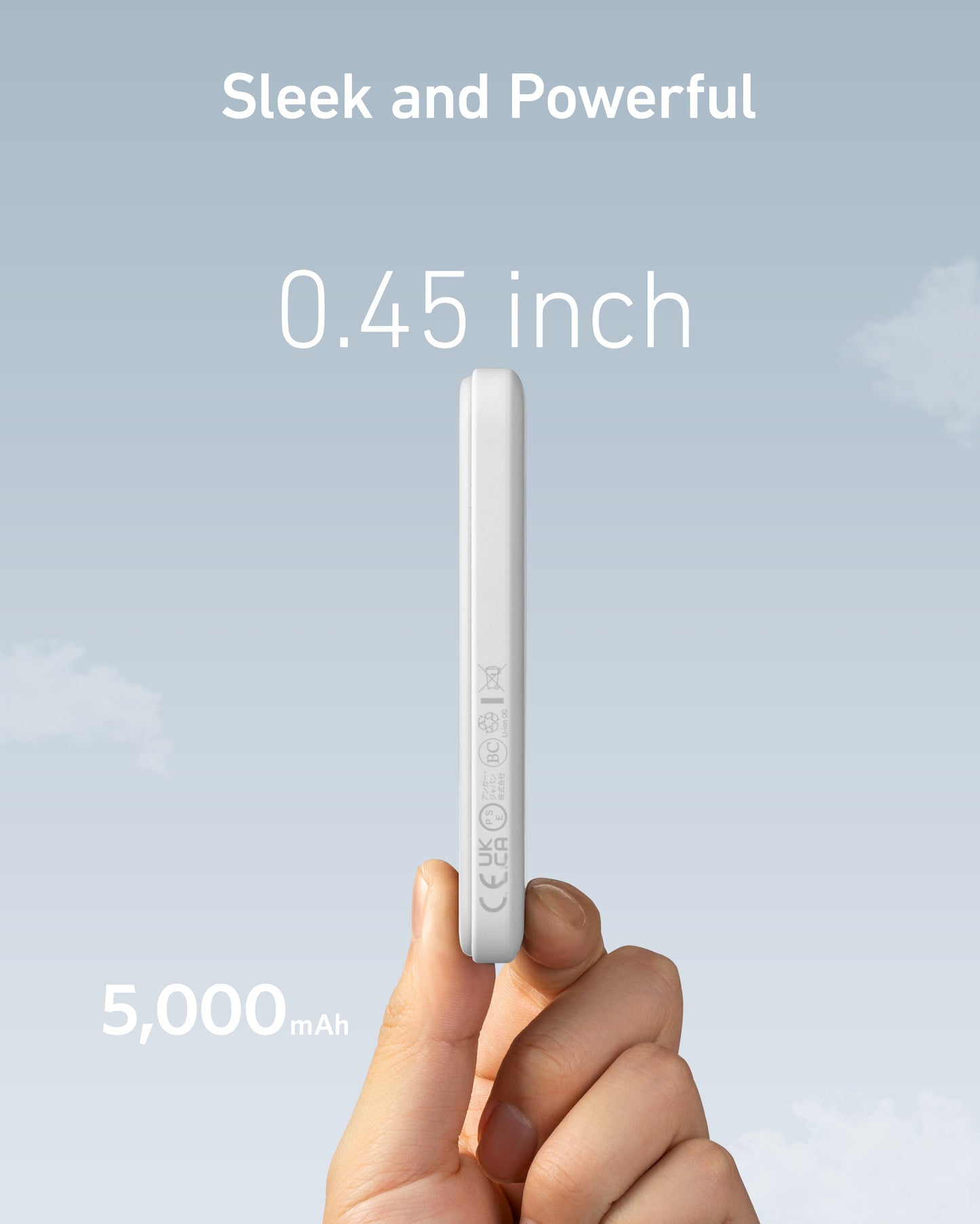 A hand holds the Anker 621 Magnetic Battery (MagGo)—a slim white device—upright against a blue sky. Large text reads “Sleek and Powerful,” “0.45 inch,” and “5,000 mAh,” highlighting its wireless charging and compact battery capacity. Icons line its side.