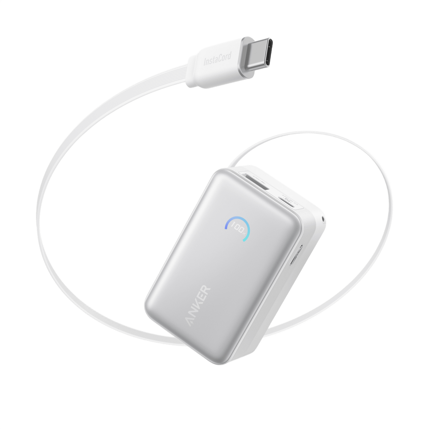 A silver Anker Nano Power Bank (10K, 45W) displays “100” on a blue LED. Its built-in retractable USB-C cable forms a loose loop above the device, showcasing fast charging against a plain white background.
