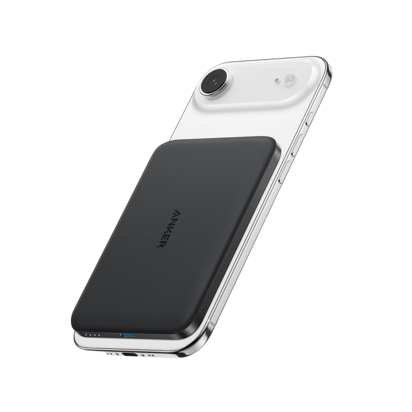 The Anker Nano Power Bank (5K, MagGo, Slim) in black is magnetically attached to the back of a white smartphone with rounded edges and a single rear camera, shown on a plain white background.