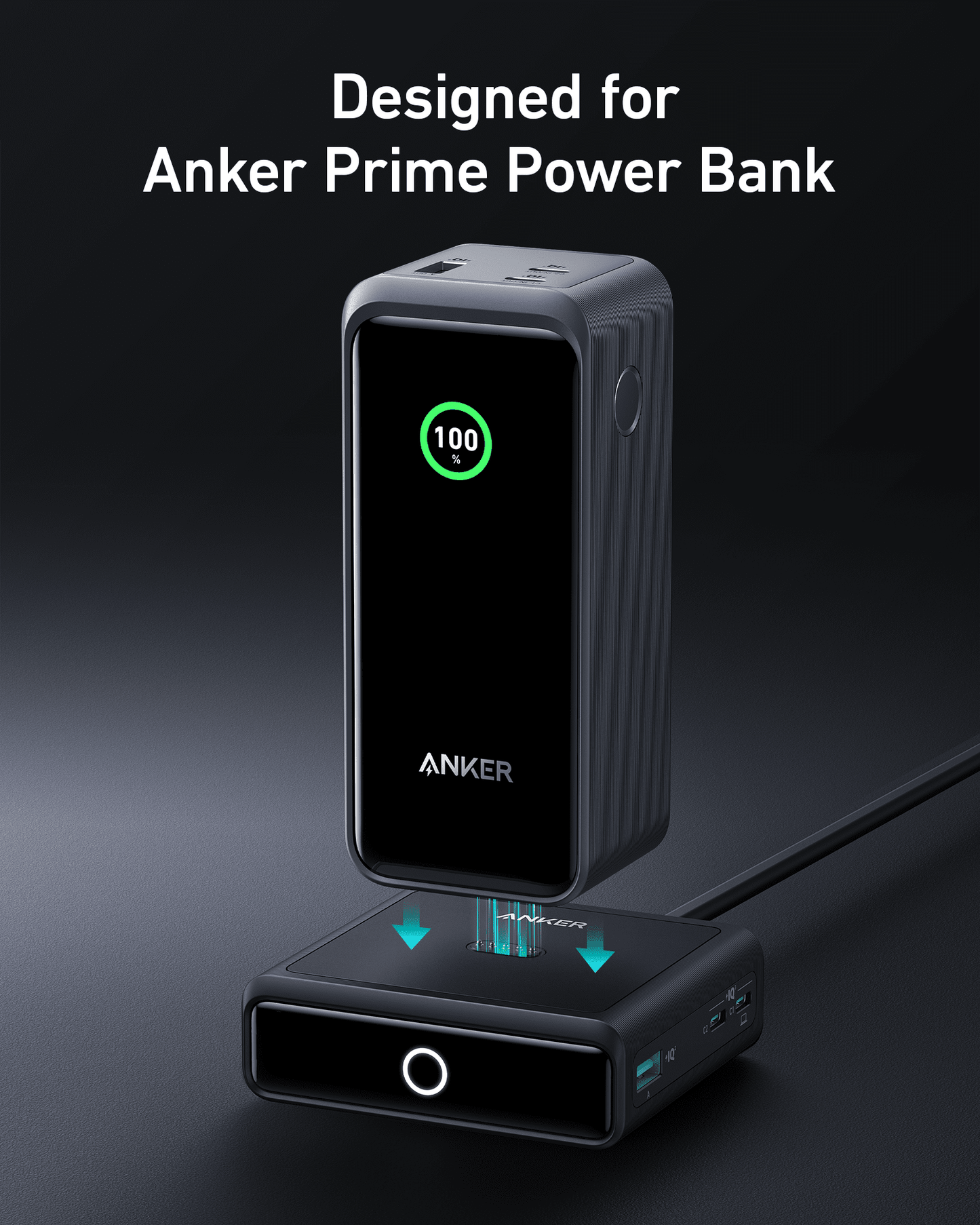 A black Anker Prime Power Bank is vertically docked on the modern Anker 100W Charging Base for Anker Prime Power Bank. The power bank shows 100% in green, with “Designed for Anker Prime Power Bank” above on a dark gray background.