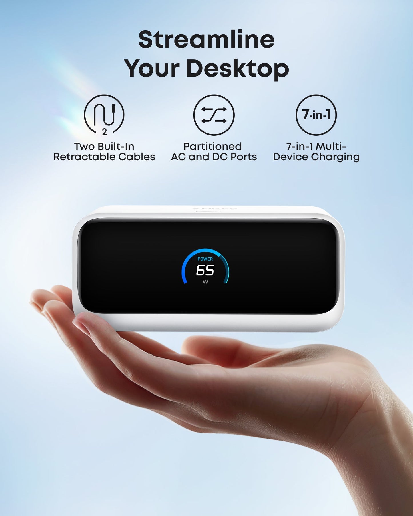 A hand holds the Anker Nano Charging Station (7-in-1, 100W) with a digital display showing “POWER 65W.” Above, icons showcase retractable USB-C cables, partitioned AC/DC ports, and versatile charging by Anker. Blue background softly lit.