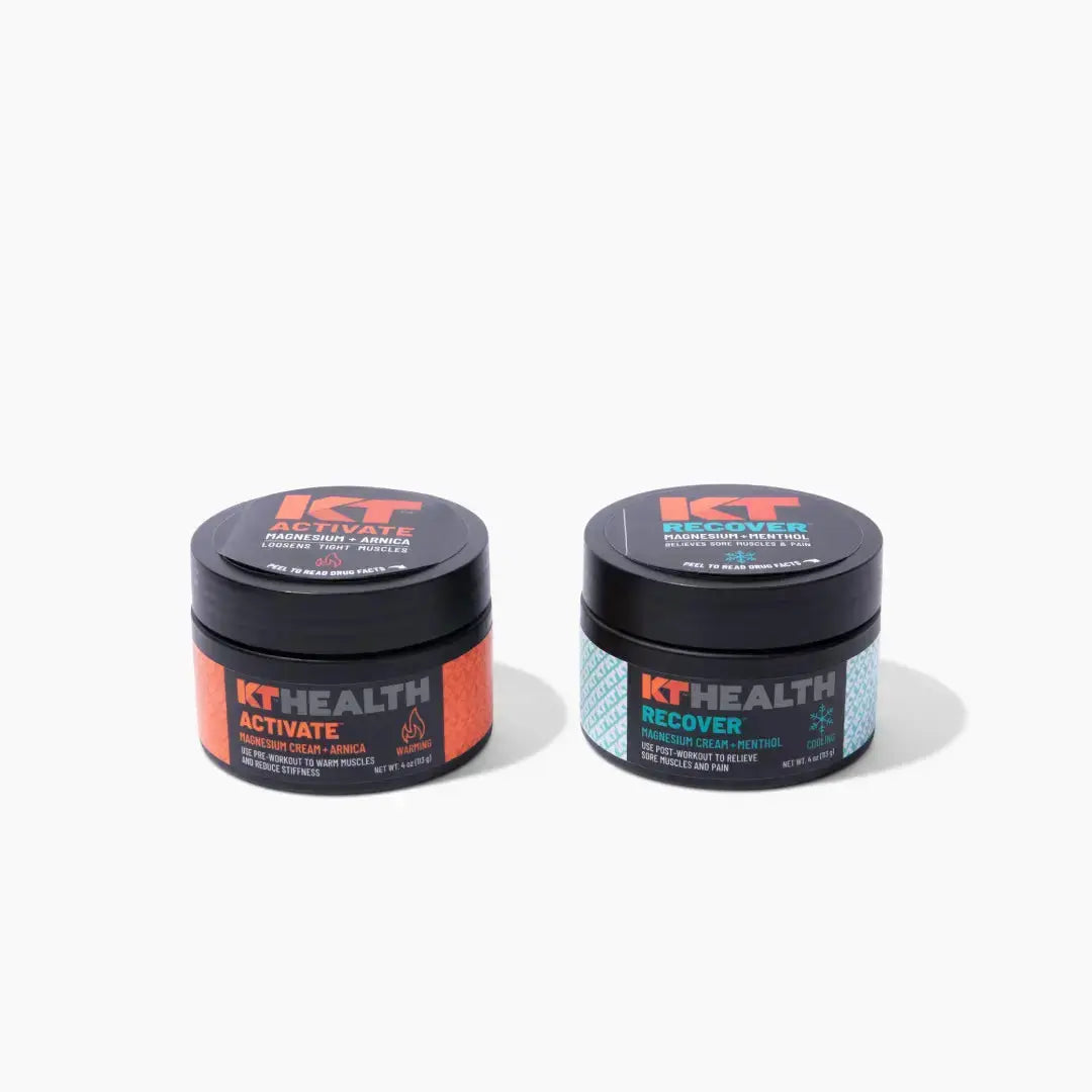 Two round jars of KT Health Magnesium Creams by KT Tape sit on a white background. Activate has orange accents and a flame icon; Recover features teal accents and a snowflake, hinting at muscle relief and recovery. Both have black lids.
