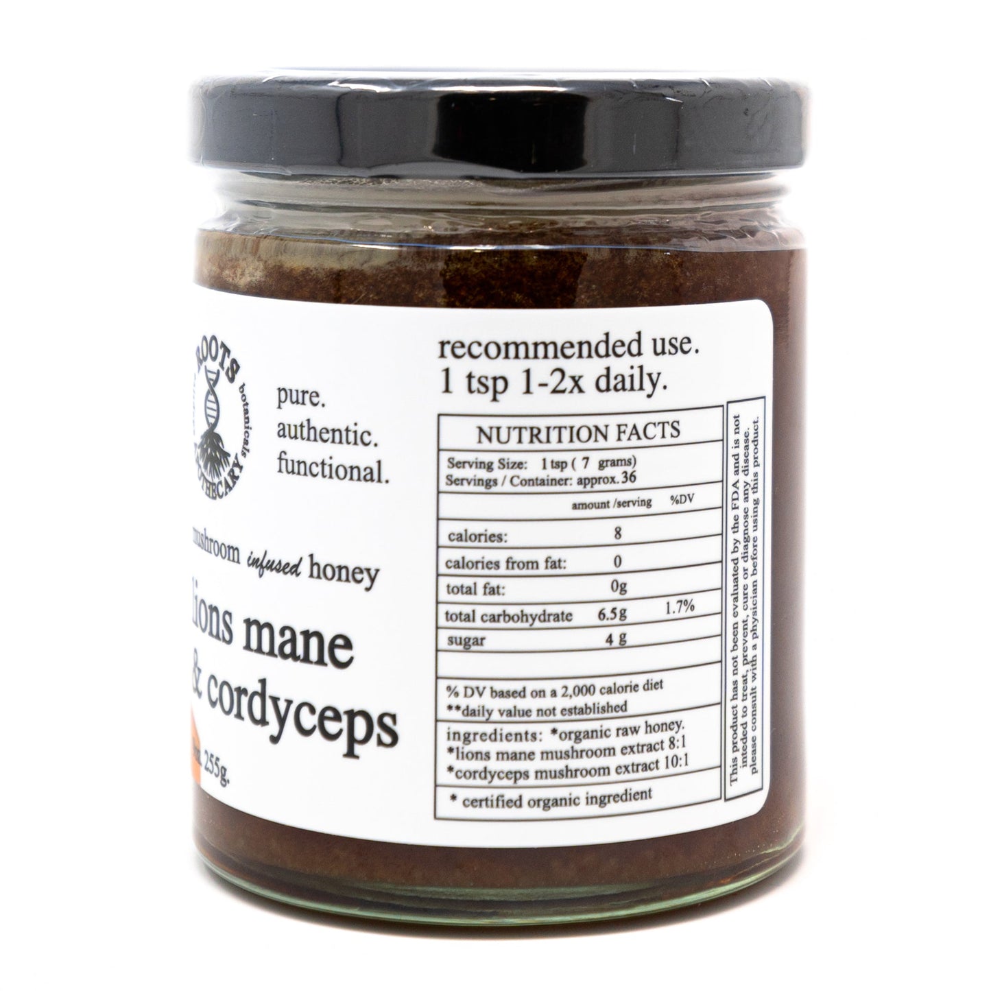 A glass jar of Roots Apothecary adaptive honey. lion's mane & cordyceps features a white side label with nutrition facts and usage instructions, a black lid, and contains dark brown mushroom-infused honey.