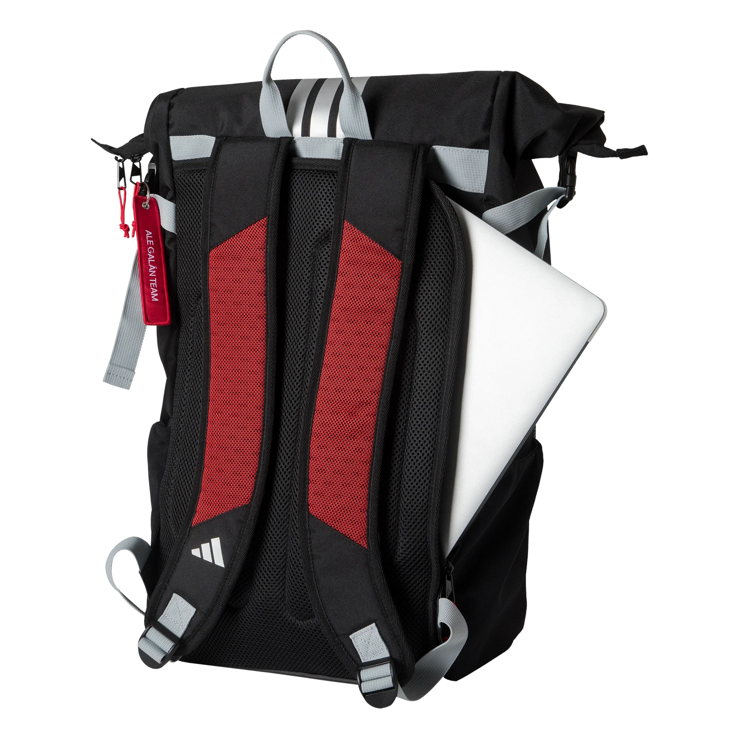 The Adidas MULTIGAME BLACK/RED Backpack 3.4 by Padel USA stands upright, featuring gray straps, red accents, padded mesh shoulder straps, and a silver laptop peeking from the main compartment with a red keychain tag on one strap.