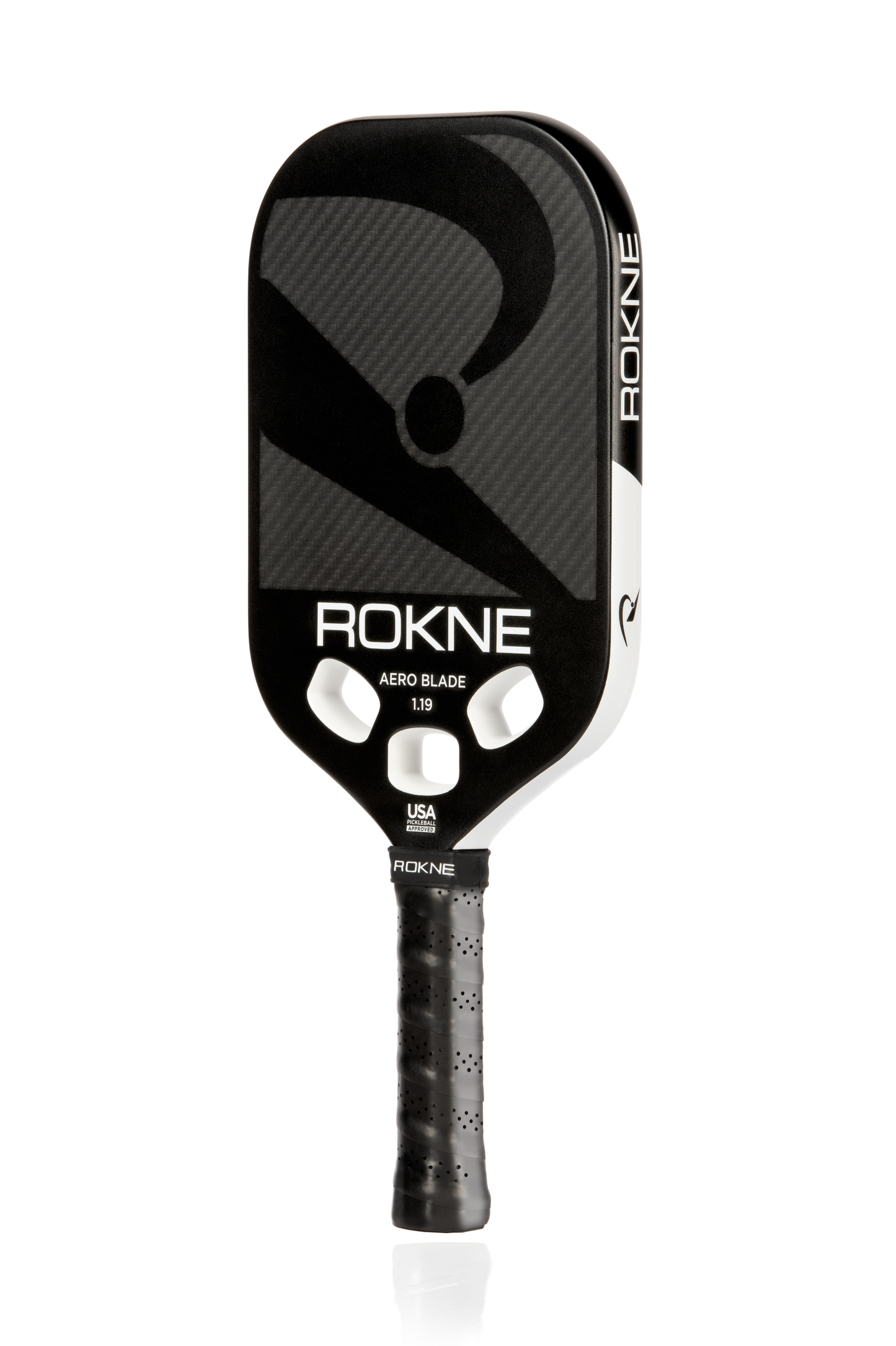 A black and white ROKNE AERO BLADE 1.19 paddle with a carbon fiber mono-frame, rounded rectangular shape, two cutout holes by the throat, textured black grip, and "ROKNE" branding on the face and handle is shown on a white background.