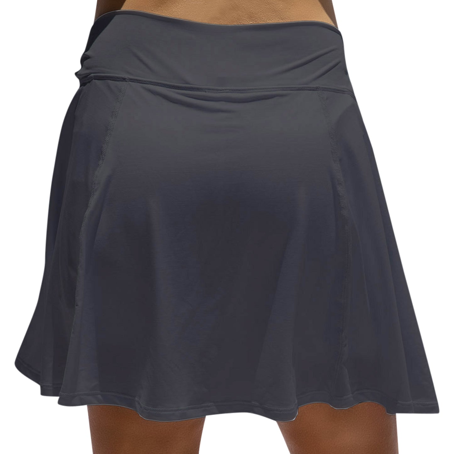 A close-up view of a person wearing the Pickleball Bella PB Aline Skort Black, a high-waisted, dark gray athletic skirt with built-in compression shorts. Its sleek design and subtle stitching evoke classic court style against a white background.